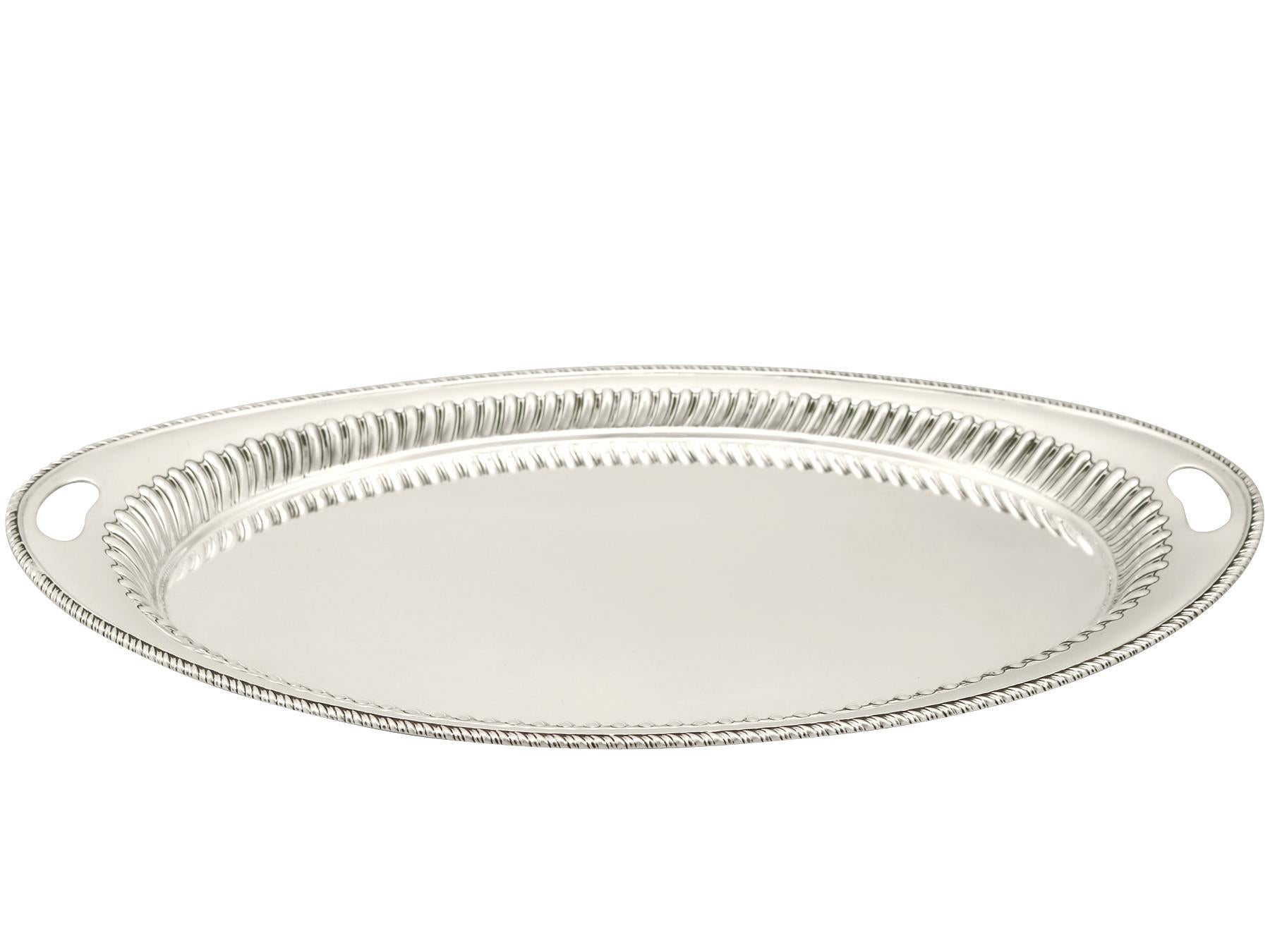 An exceptional, fine and impressive antique Victorian English sterling silver tray; an addition to our antique silver teaware collection.

This exceptional antique Victorian sterling silver tray has a rounded Navette shaped form.

The surface of