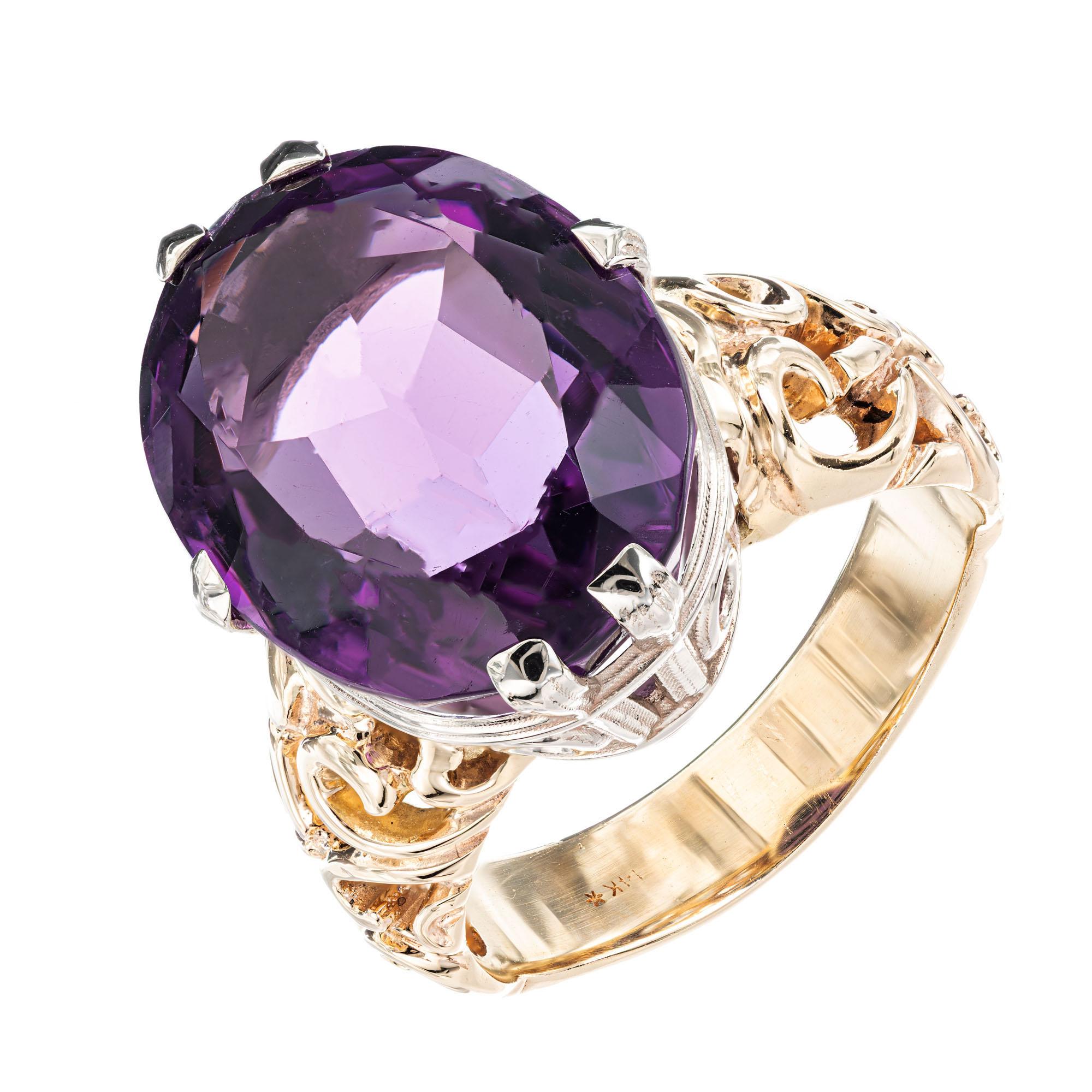 Purple oval Amethyst with a slightly reddish background color in a custom made open swirl design 14k yellow gold six prong setting. 14k white gold crown. 

1 oval Amethyst approx. total weight 18.93cts, 19.4 x 15.0mm
Size 9.5 and sizable
14k Yellow