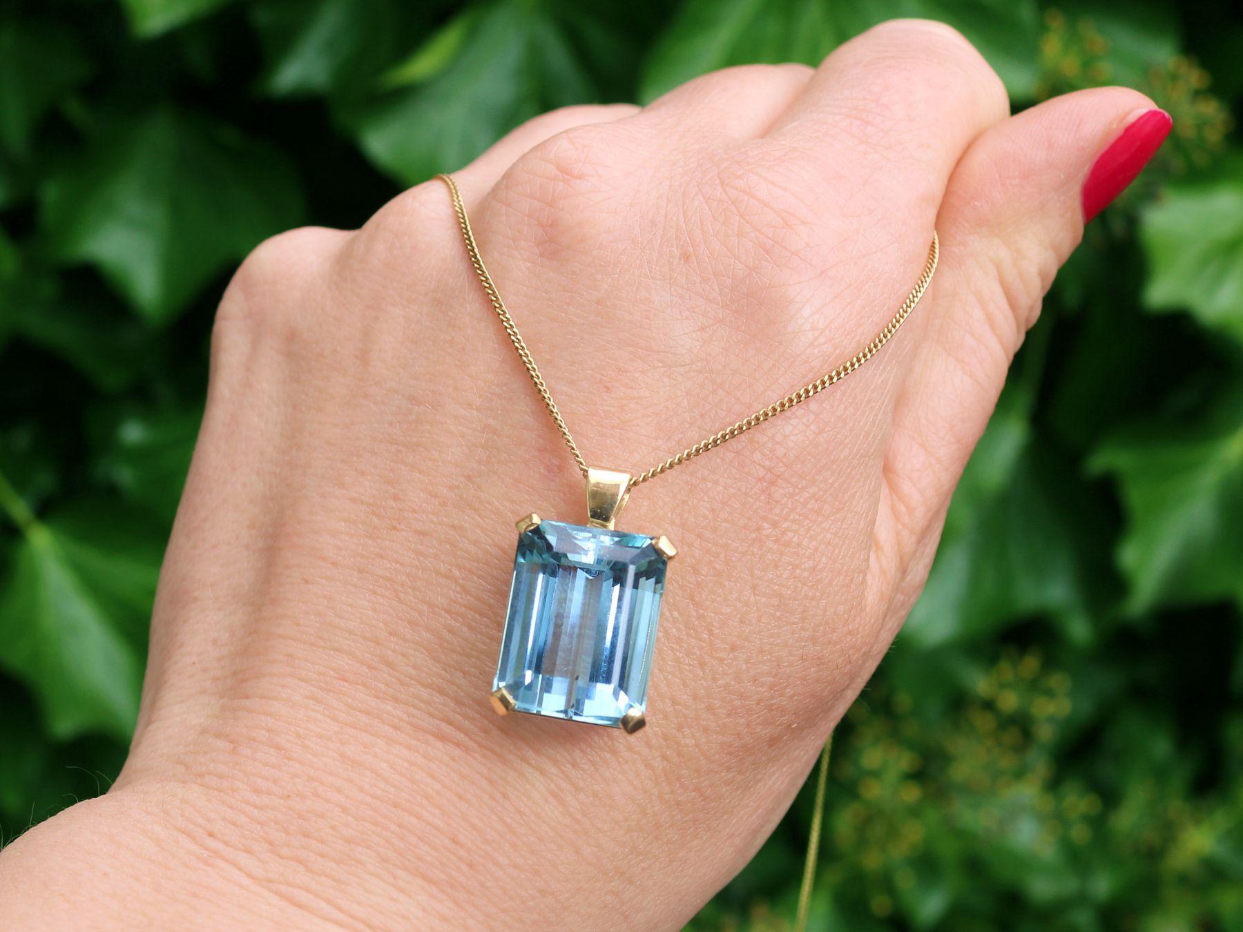 A stunning, fine and impressive vintage 18.93 Carat aquamarine and contemporary 18 karat yellow gold pendant; part of our diverse vintage jewelry and estate jewelry collections.

This stunning, fine and impressive aquamarine pendant has been crafted