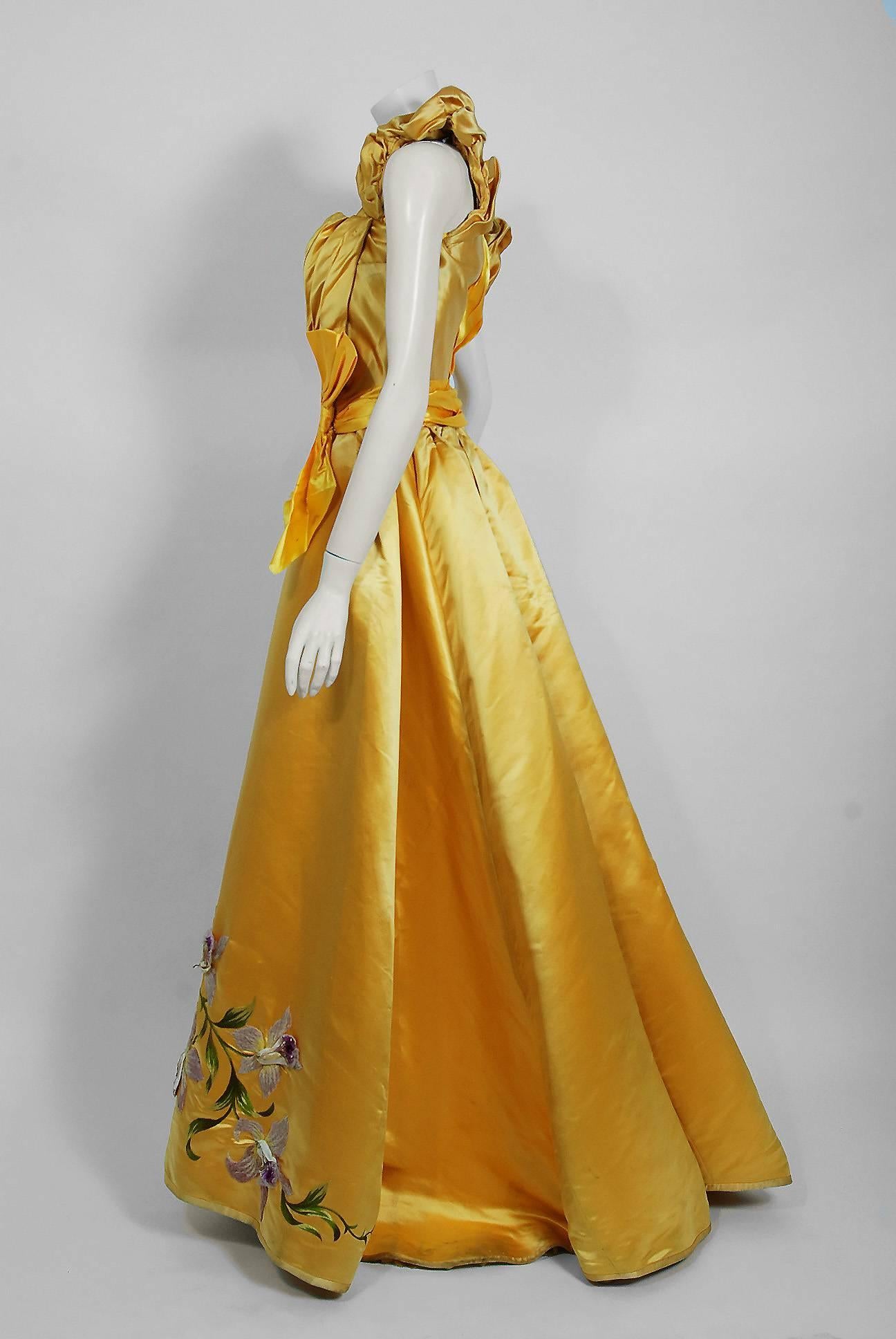 Undiminished by time, this 1895 Mme Arnaud on 16 Rue Bassano Paris couture ensemble still casts its seductive spell. An exceptional Victorian evening ensemble fashioned from vibrant sunshine yellow silk-satin. The gorgeous three-dimensional purple