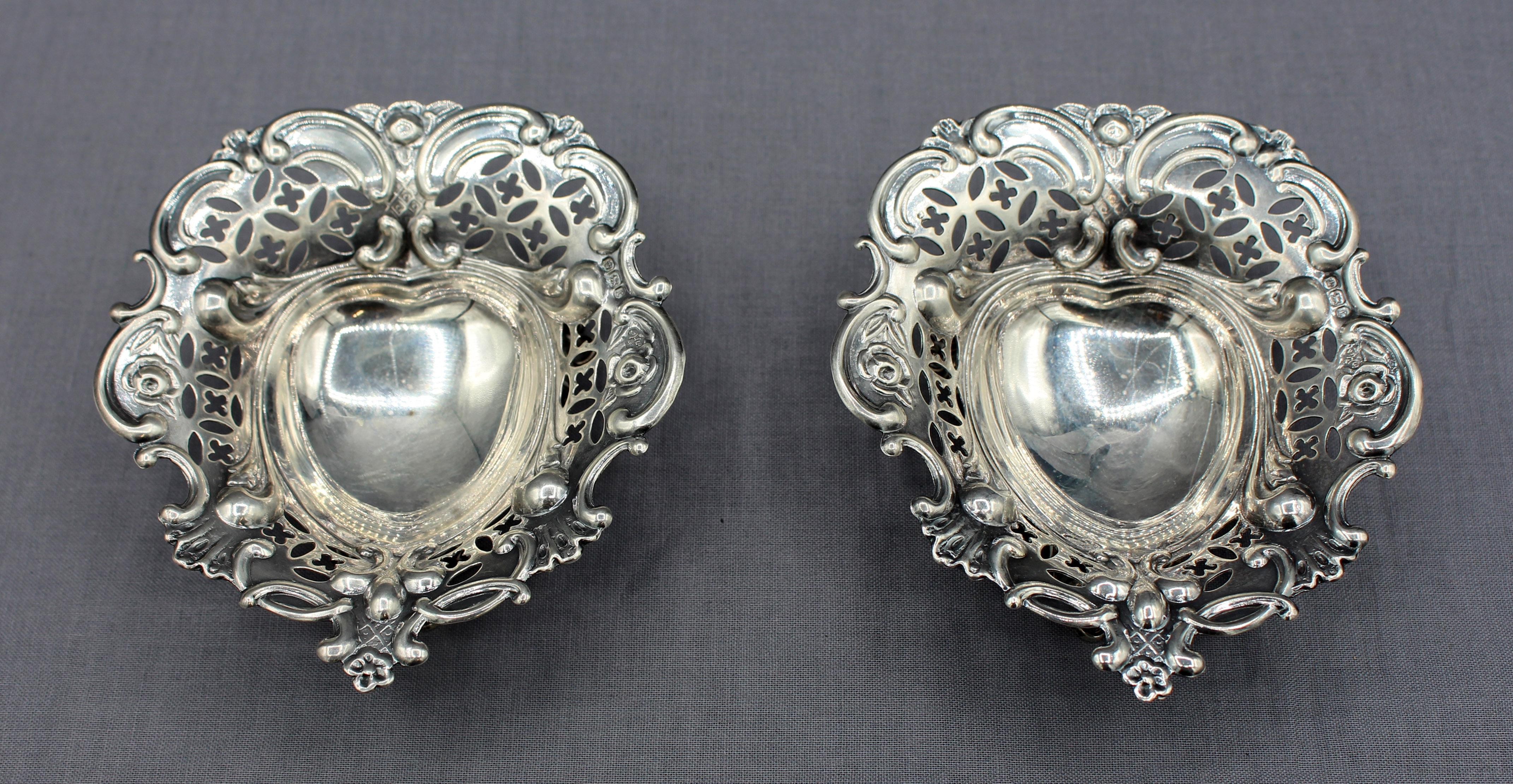 Pair of sterling silver cut work heart shaped dishes, Sheffield, England, 1895. In as is presentation box. Made by William Hutton & Sons. 2.50 troy oz.
Each dish: 4