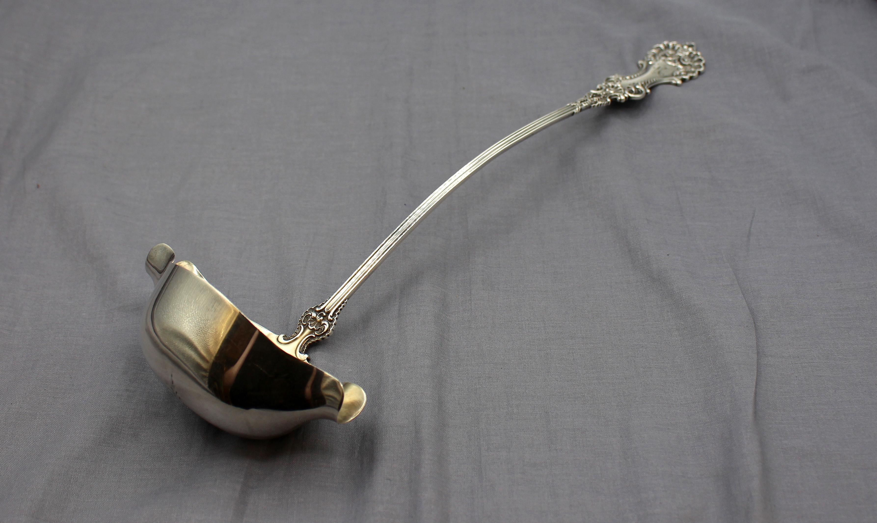 1895 patented American sterling silver punch ladle, Pompadour by Whiting Gorham. Softly gilded bowl with twin spouts. Rich baroque design. Monogram 