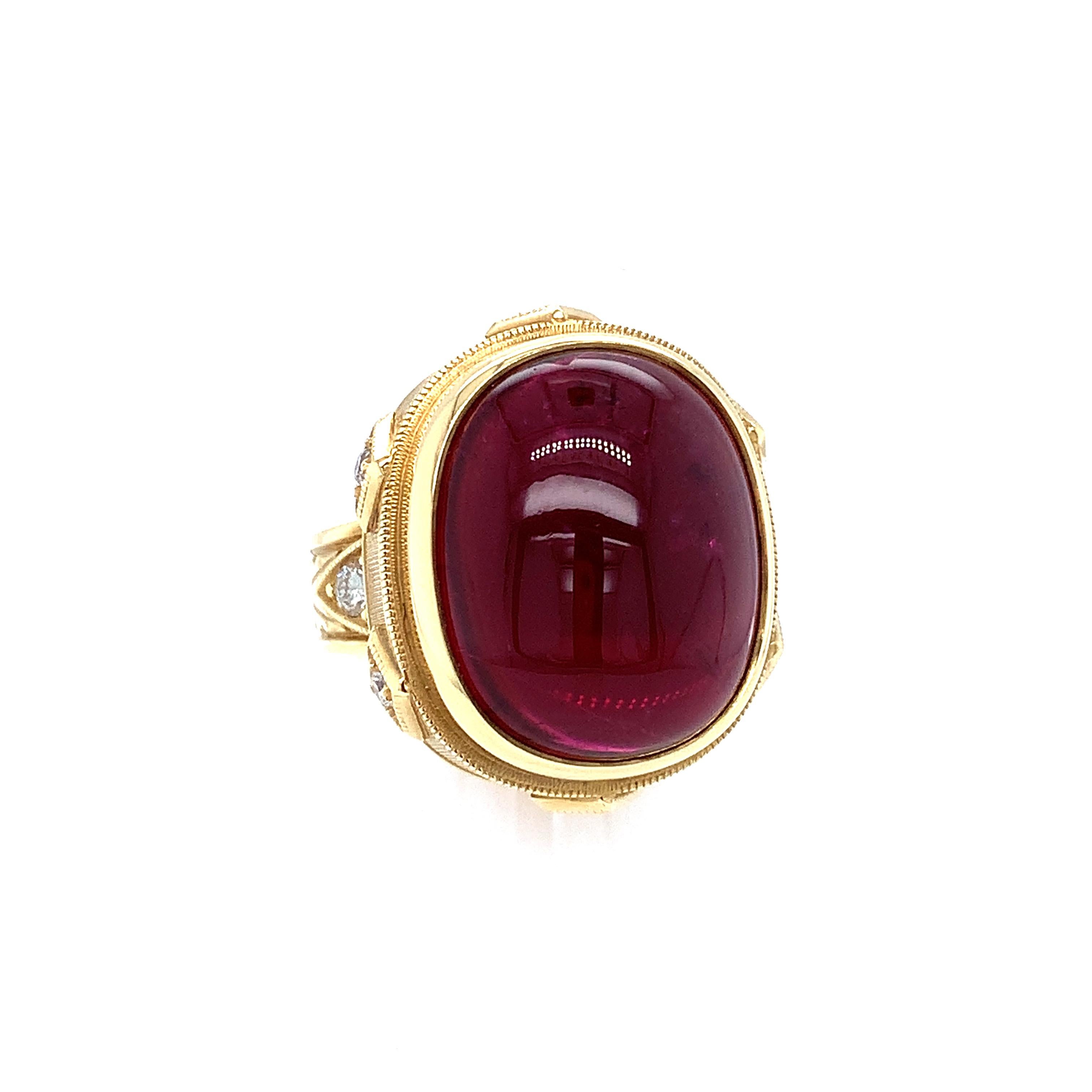 This beautiful 18k yellow gold handmade ring features a gorgeous 18.98 carat, intense fuchsia rubellite tourmaline cabochon with exceptional clarity! Our Master Jeweler created this magnificent tourmaline ring in one of our most popular signature