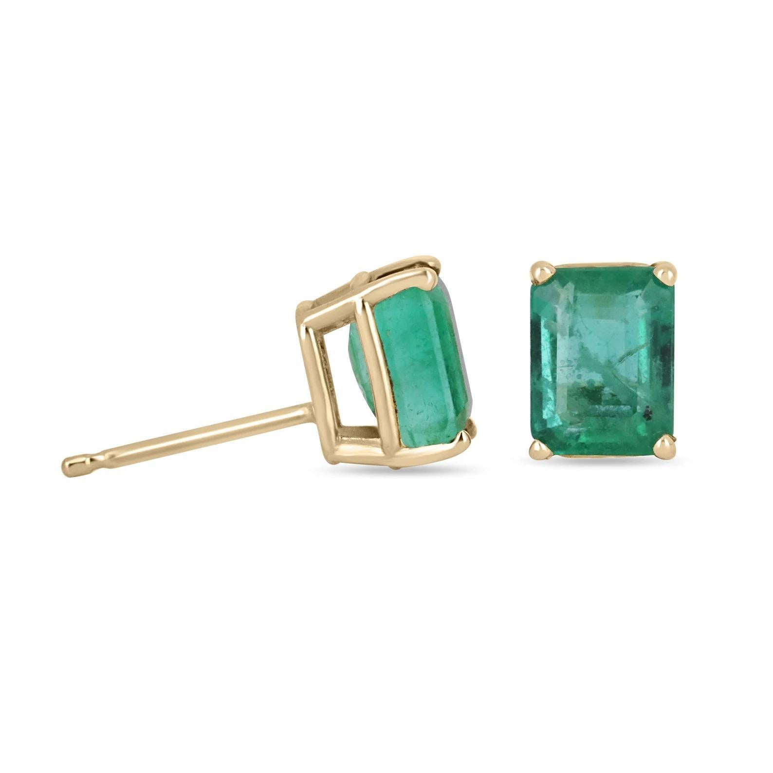 Featured here is a beautiful set of emerald cut emerald studs in fine 14K yellow gold. Displayed are dark green emeralds with very good transparency, accented by a simple four-prong 14K gold mount, allowing for the emerald to be shown in full view.