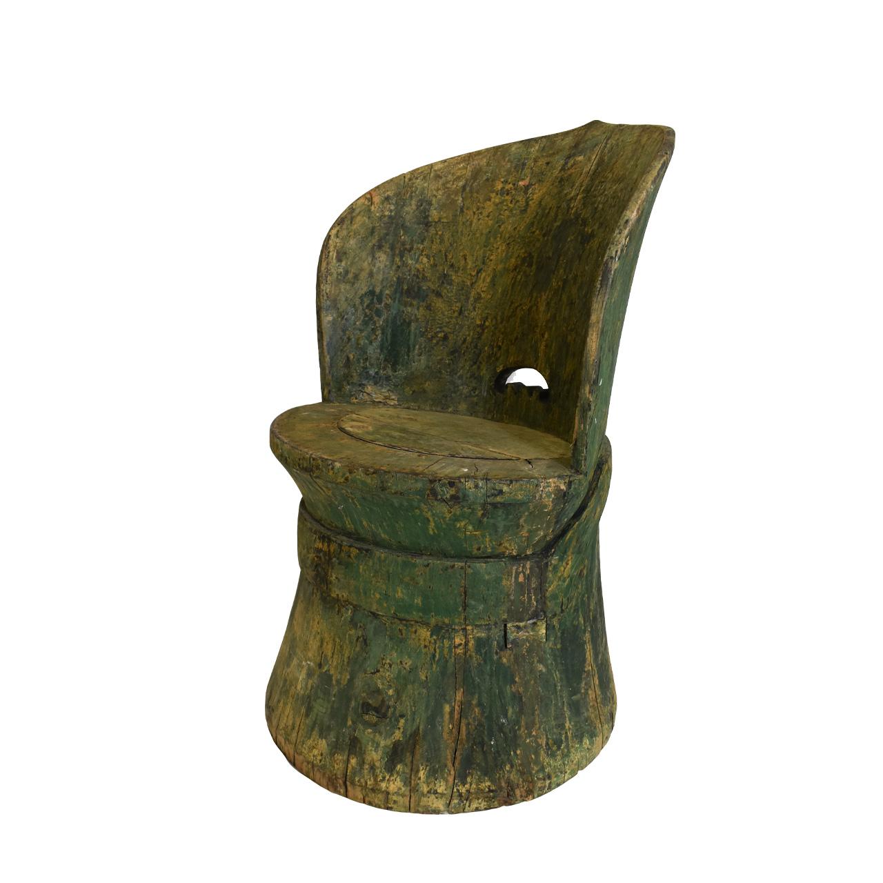 A Swedish Kubbestol chair carved from a tree trunk. The bottom is hollowed and top carved to make the back. Considered Swedish Folk Art.