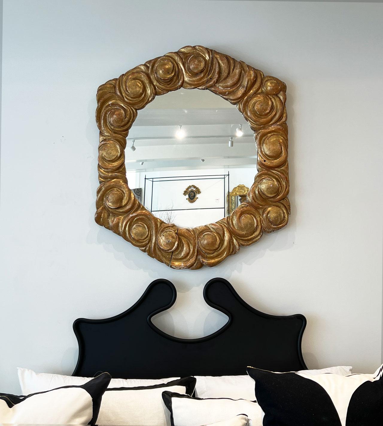 Statement mirror with cloud shapes surrounding a round mirror.