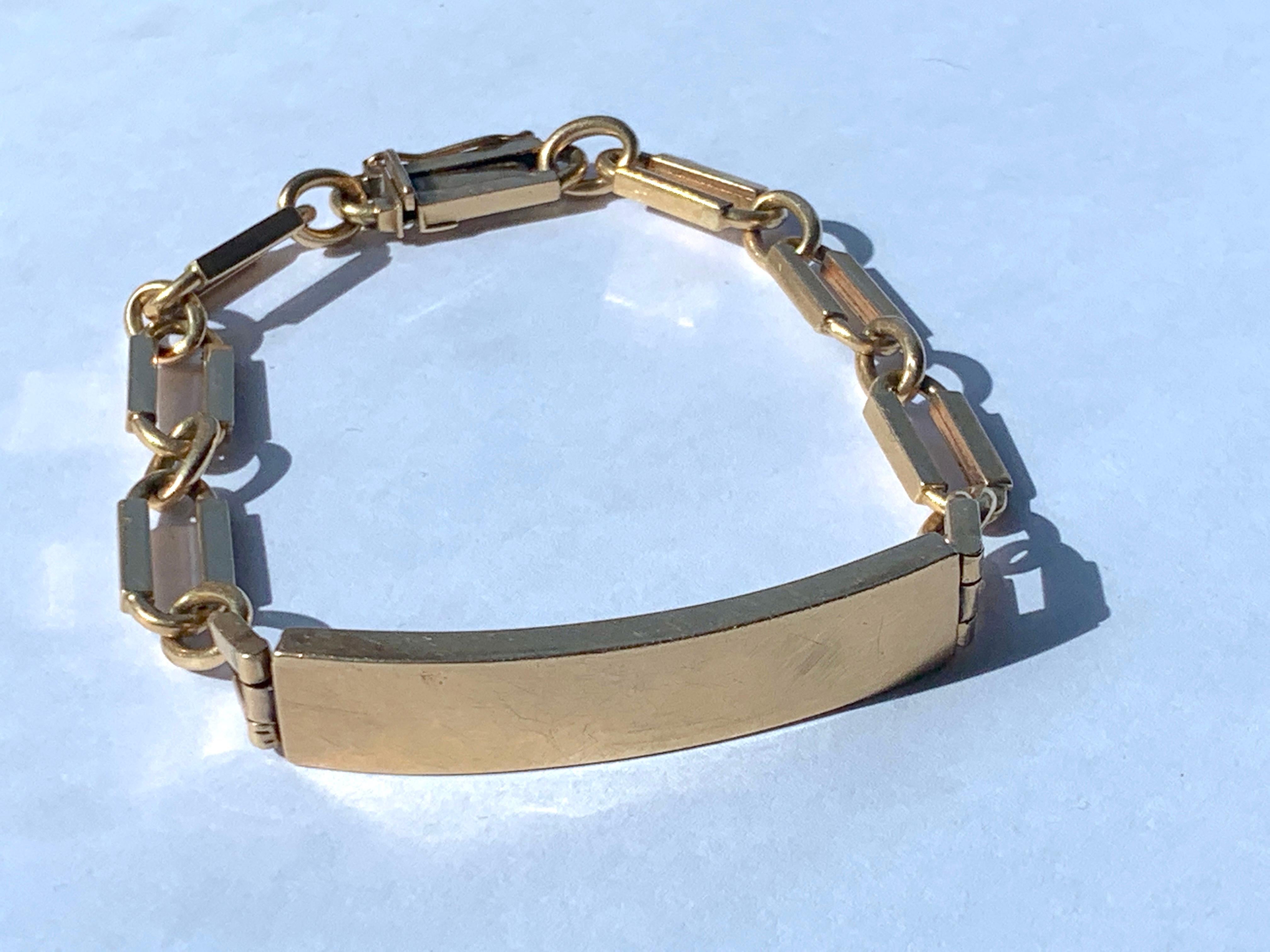 18ct Gold Mid Century 
Identity Bracelet.
Stamped 18k 750 
once on the clasp and one 18k on the edge of the inside of the Bar 
The bar is hollow as well as the links 
There are some surface scuffs to the front of the bar - these are visible in the