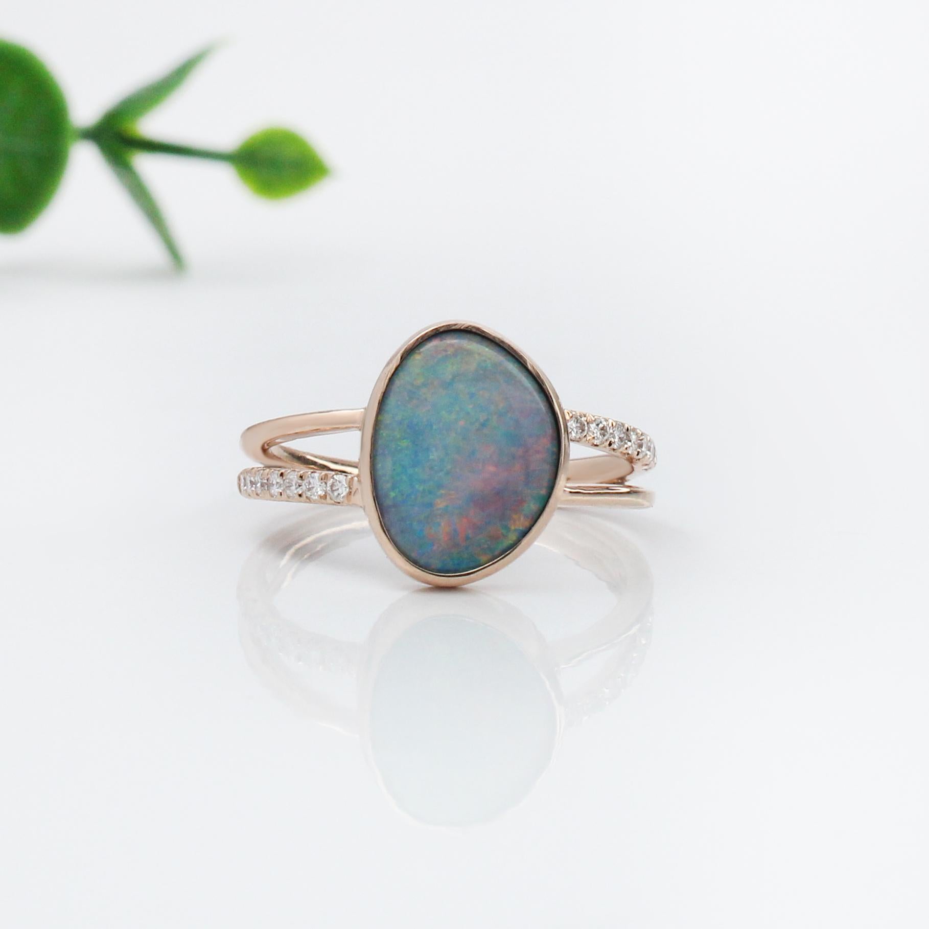 This striking cocktail ring showcases a captivating 1.83 carat Boulder Opal in a cabochon cut, complemented by round natural earth mined diamonds, set in a solid 14k rose gold band. This Boulder Opal ring makes a beautiful October birthstone gift