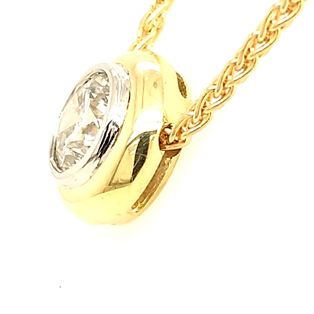 This absolutely stunning necklace is truly a piece to be noticed. The 1.8 carat diamond is nestled in a flawless platinum bezel surrounded by bright 18 karat yellow gold. The contrast between platinum and yellow gold draws the eye to the sparkling