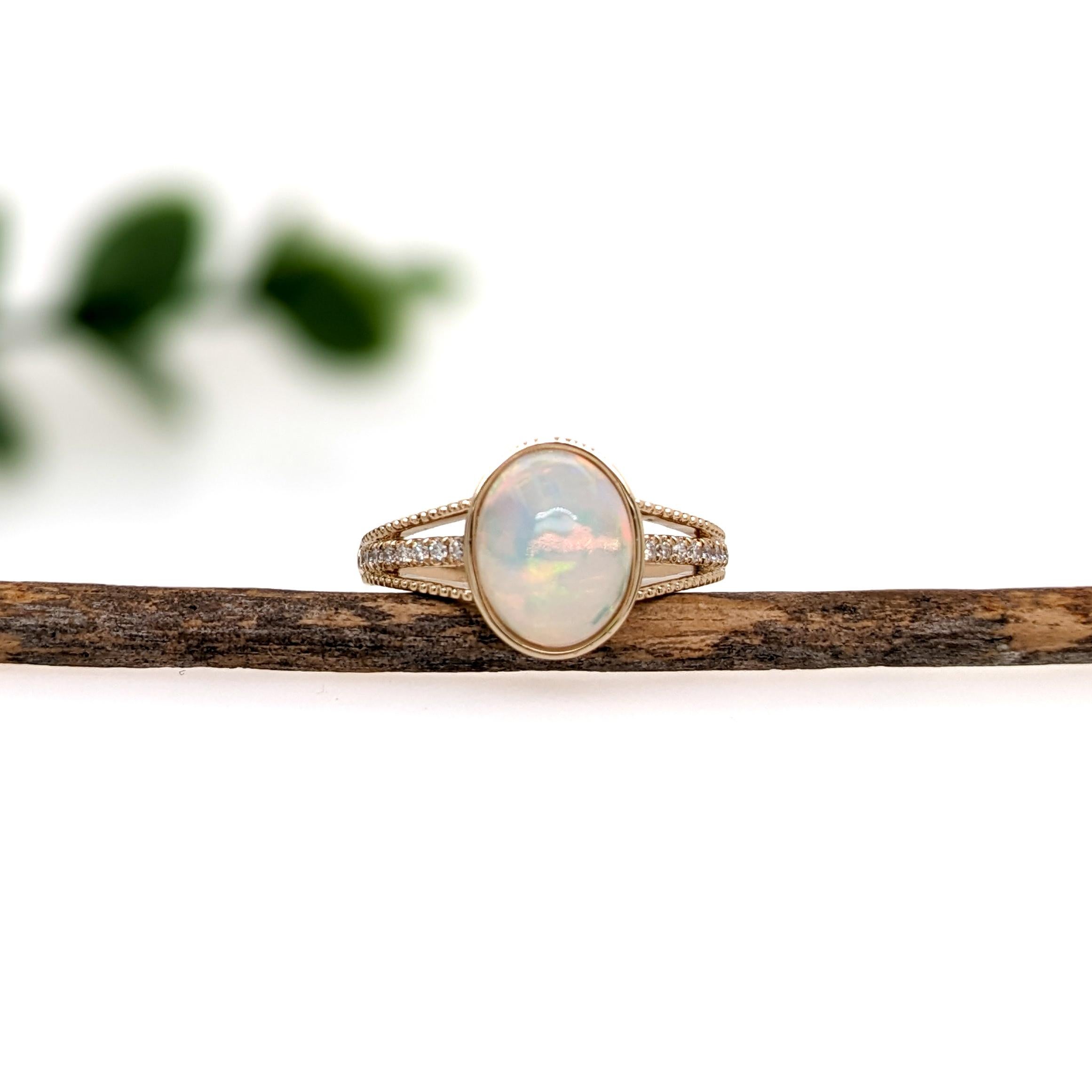 This exquisite ring showcases a 1.86 carat Opal gemstone with natural earth mined diamonds set in solid 14K gold. The band features intricate milgrain detailing, enhancing its sophisticated design. Ideal for making a statement, this cocktail ring is