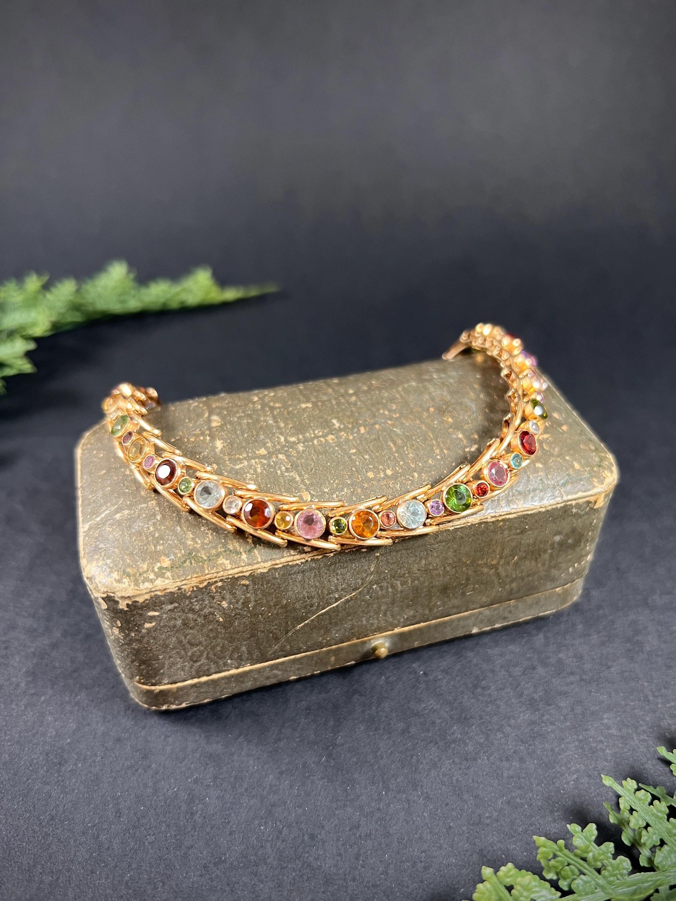 Vintage Harlequin Bracelet 

18ct Rose Gold Tested

Circa 1980s

Introducing a stunning vintage 18ct rose gold harlequin bracelet from the 1980s. This exquisite piece features a beautiful arrangement of gemstones in alternating sizes, including