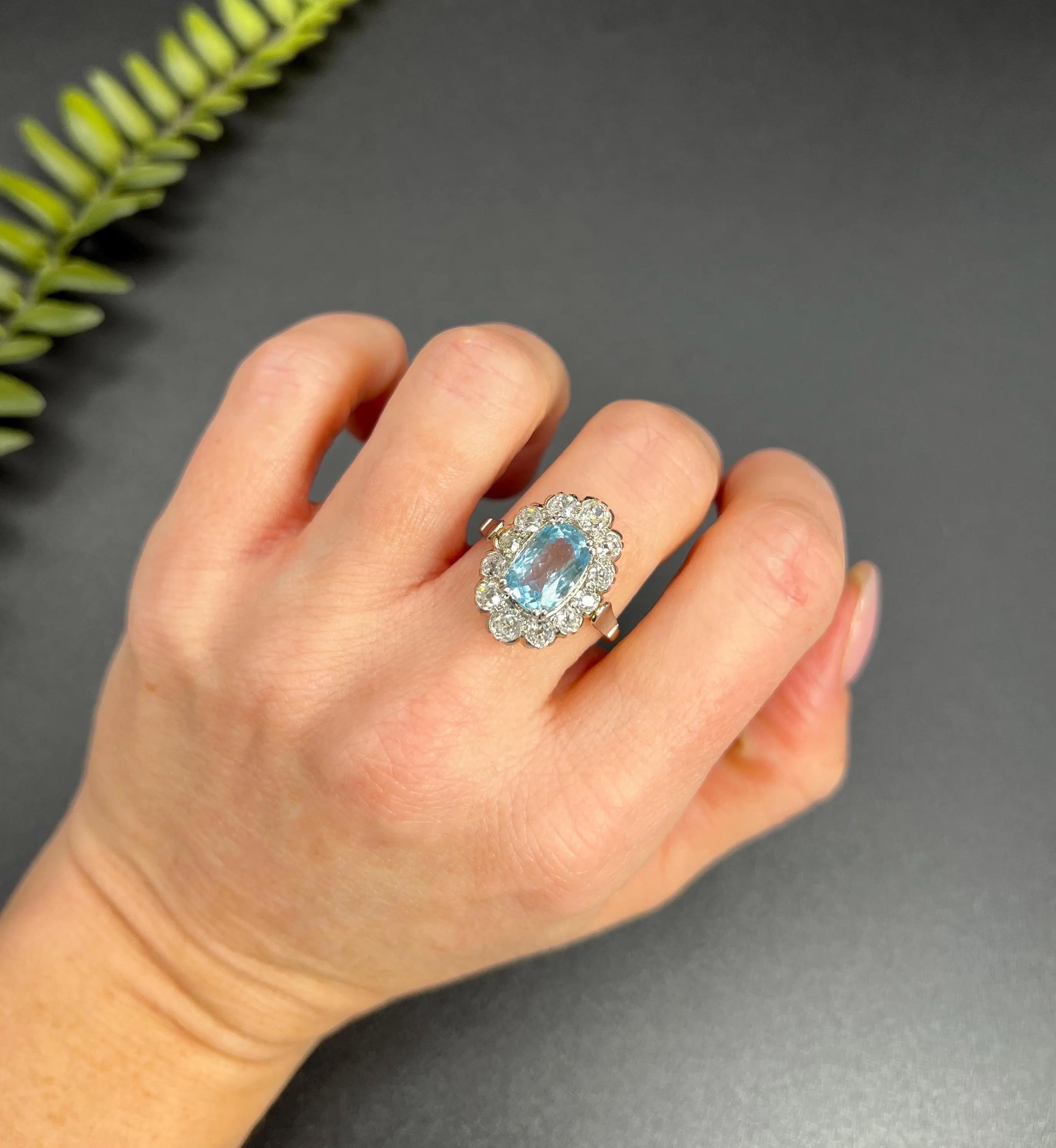 Vintage Aquamarine Cluster Ring 

18ct Yellow & White Gold Tested

Circa 1960s 

Discover the elegance of the past with this exquisite vintage cluster ring from the 1960s, crafted in 18ct yellow and white gold. The centrepiece of this fabulous piece