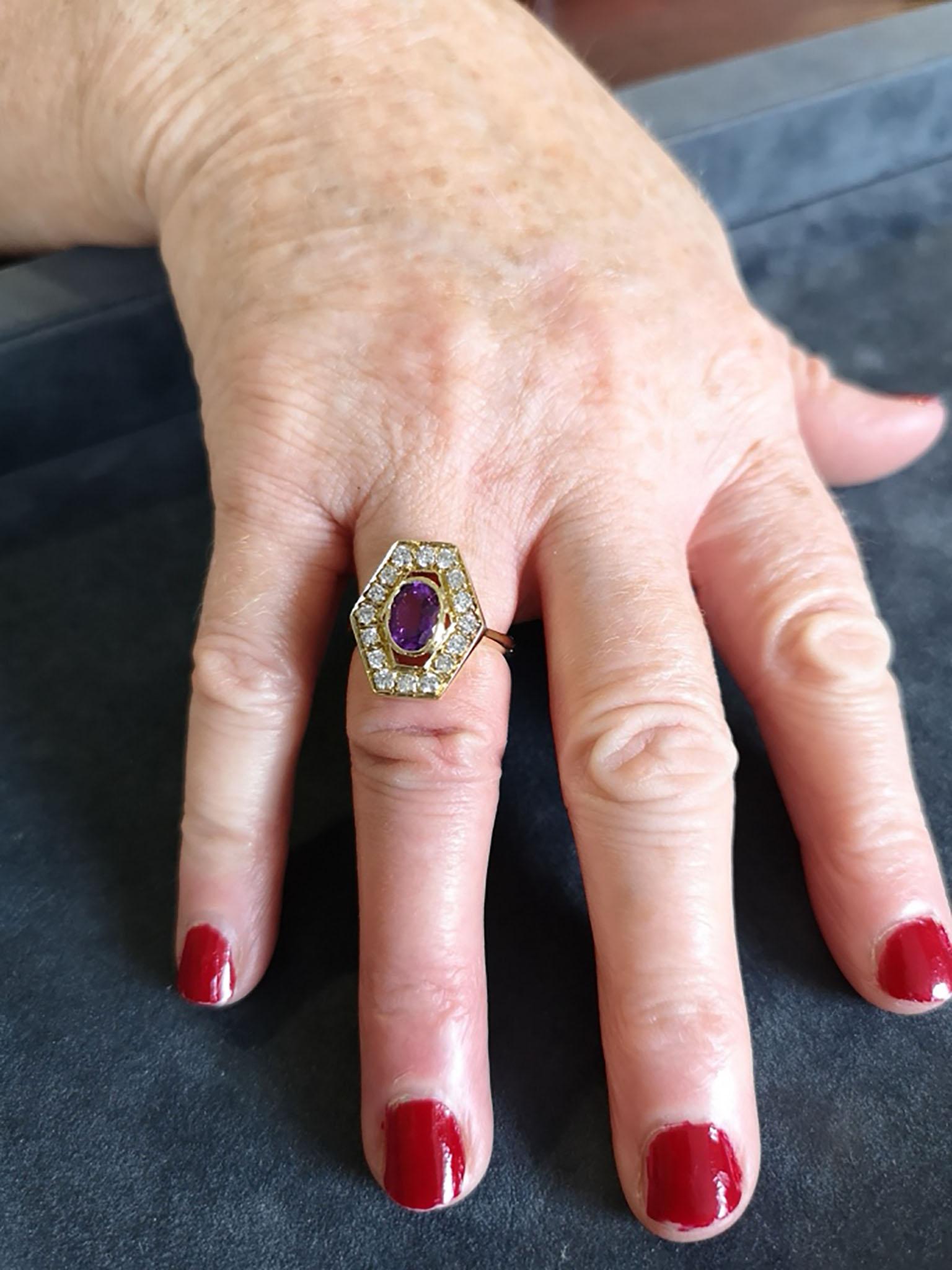 A very unusual and super stylish openwork amethyst and diamond cocktail ring. The central deep purple, oval-cut amethyst of approximately 1.25 carats mounted in an 18-carat yellow gold bezel, surrounded by a hexagonal single row of bead-set
