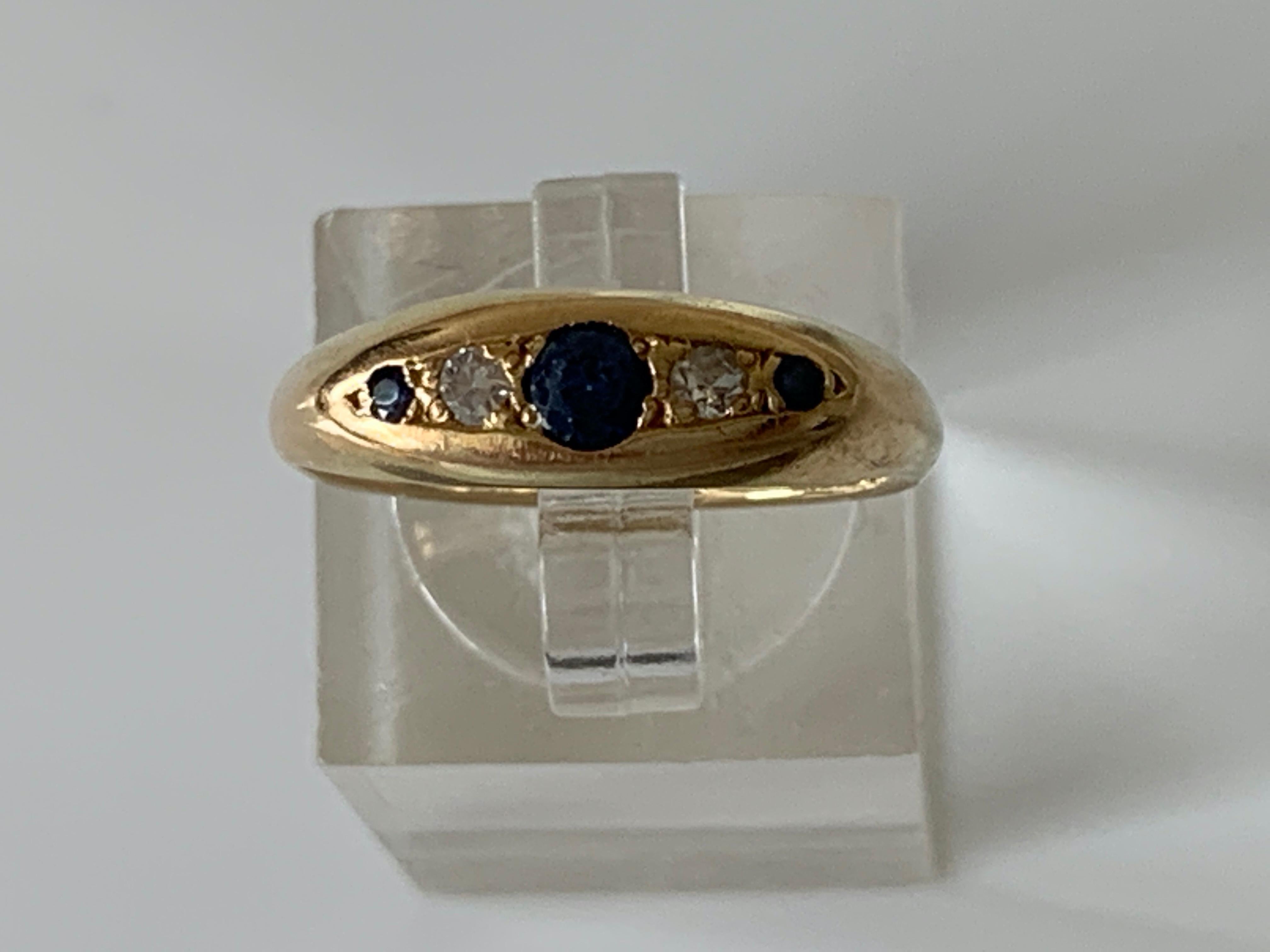 Antique 18ct Gold Ring
Dark Blue Sapphires - 0.13 Carat in total
main sapphire 0.10 Carat 
with two Diamonds either side - 0.06 carat
Stamped 18ct 
U.K Size P 1/2
U.S Size 7 3/4