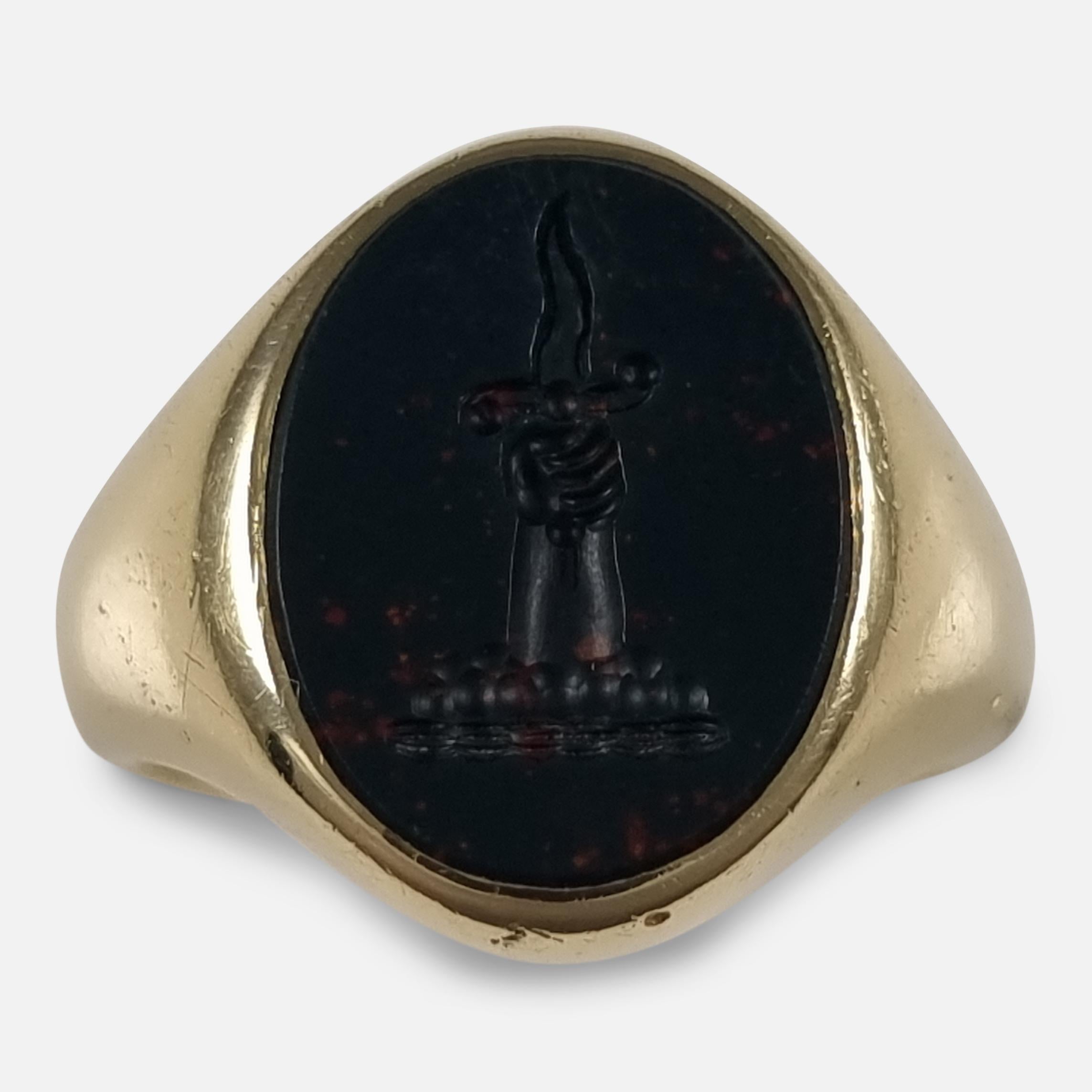 This 18ct yellow gold signet ring features a bloodstone set into an oval head, engraved with an intaglio family crest depicting a hand rising from a cloud to grasp a wavy blade.

Associated with the Chapman, Colles, Colvil, Colville, Ingle, Lander,