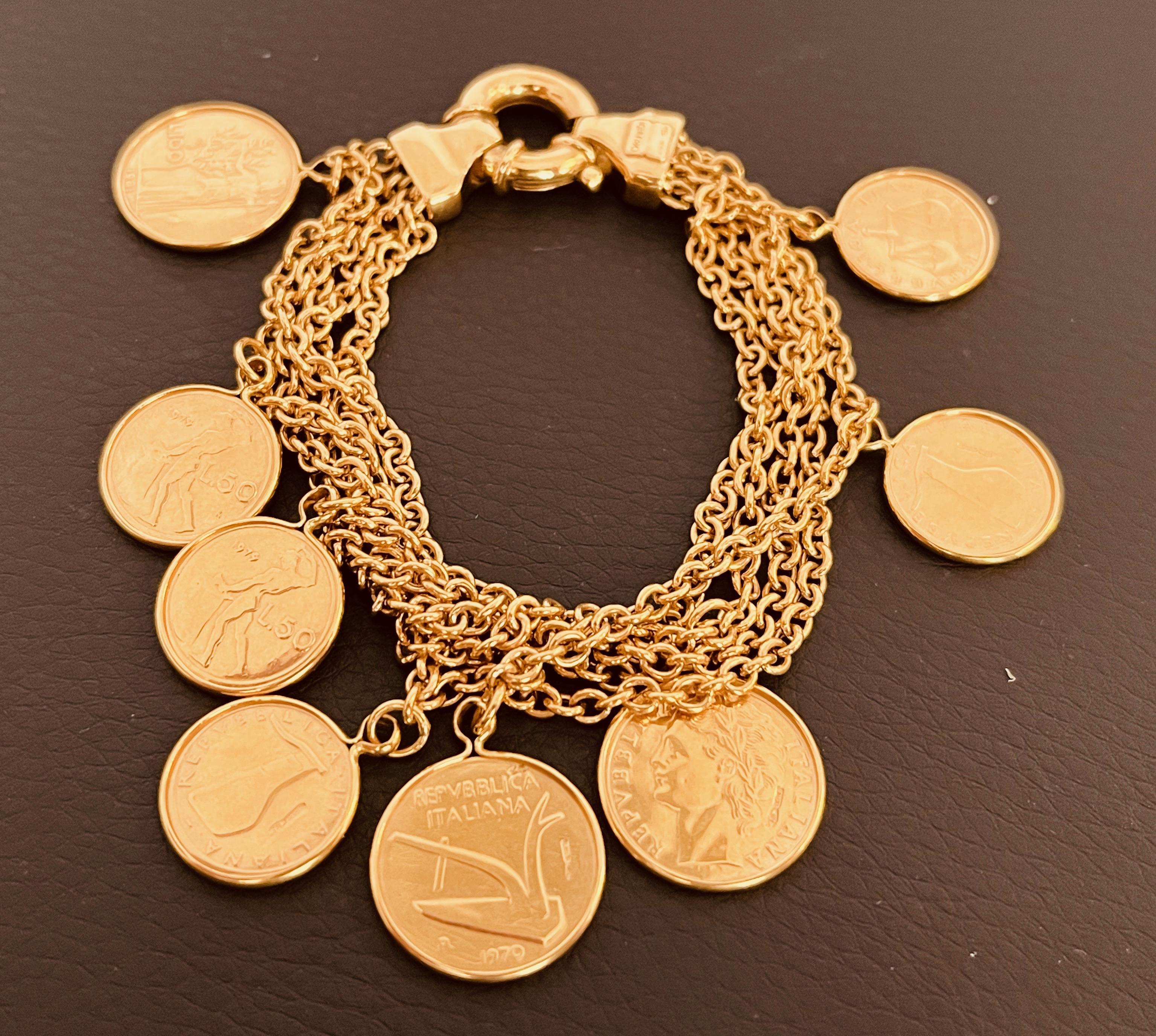 A 18ct gold vintage coin bracelet 5 rows of trace chain suspending 8 Italian gold coins to a large bolt ring clasp. Chains side by side 1cm wide. 19cm long. Circa 1980's. Signed Olandi with Italian control marks. Total weight: 38grames. Price: