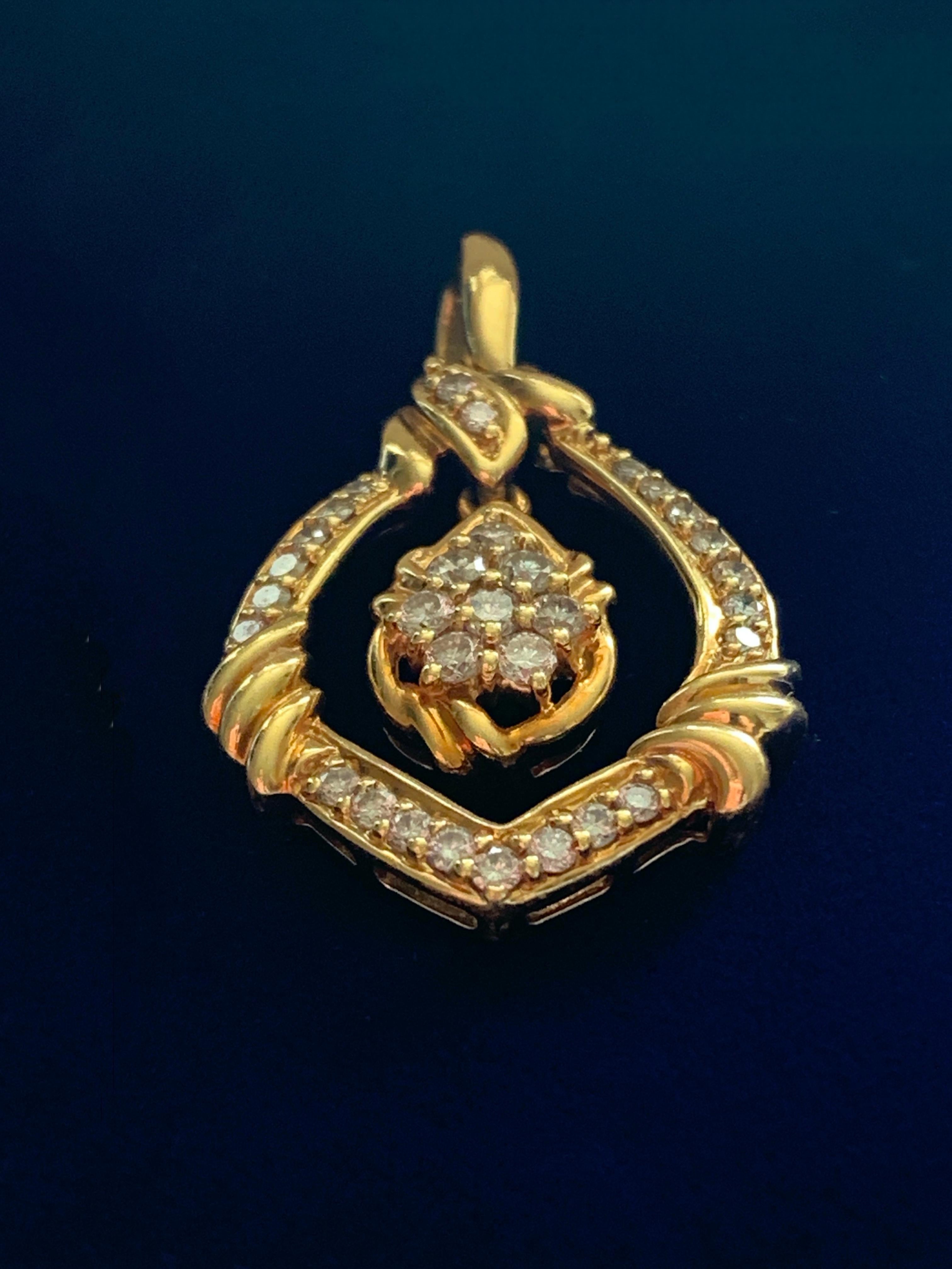 Beautiful 18ct Gold Diamond pendant 
Exquisite natural diamonds amounting to One Carat
Central section swings freely 
Stamped 18k  & 1.00 ( for diamond carat weight)
This pendant was photographed in daylight and twinkle as if under candle