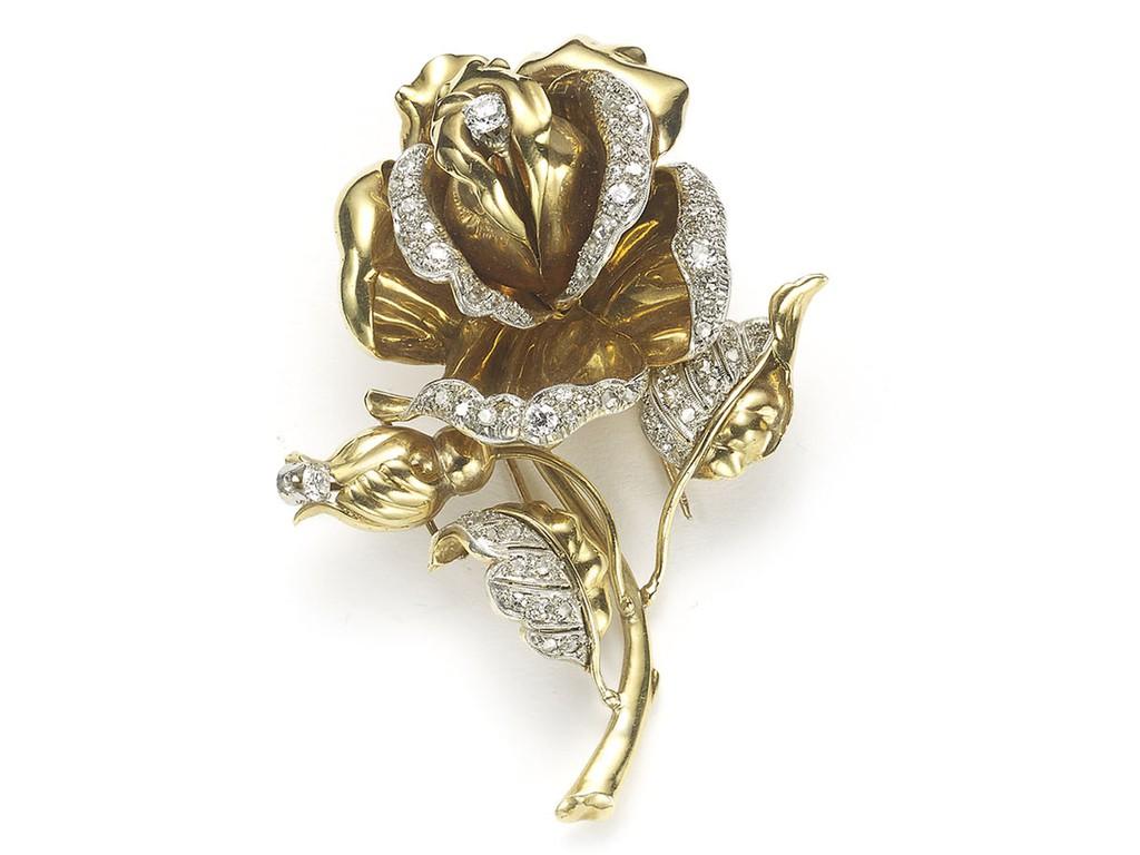 A vintage rose brooch, mounted in 18ct yellow gold , with old-cut, eight-cut and rose-cut diamonds set to the petals and leaves, circa 1965. 