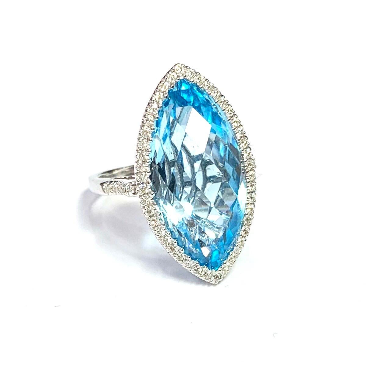 18ct White Gold Edwardian Style Marquise Shape Blue Topaz and Diamond Cluster Ring. Set with one central buff cut Blue Topaz. Surrounded by round brilliant cut diamonds and diamond shoulders.

Approximate Blue Topaz weight : 5.50ct
Approximate total