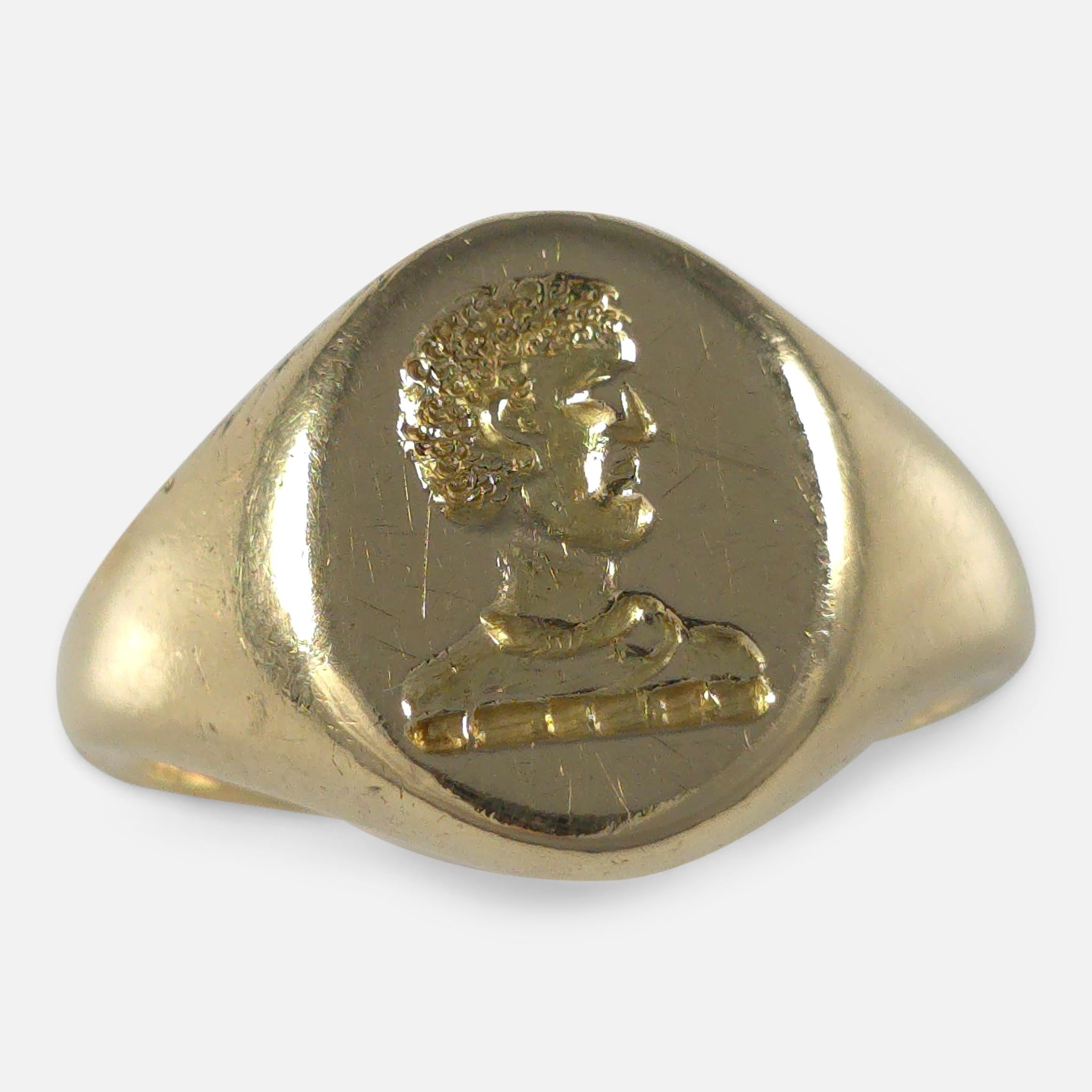An elegant 18ct yellow gold signet ring featuring an oval head intricately engraved with an intaglio family crest.

The ring bears the Edinburgh assay office hallmark, along with the '750' Common Control Mark, signifying its 18 carat gold
