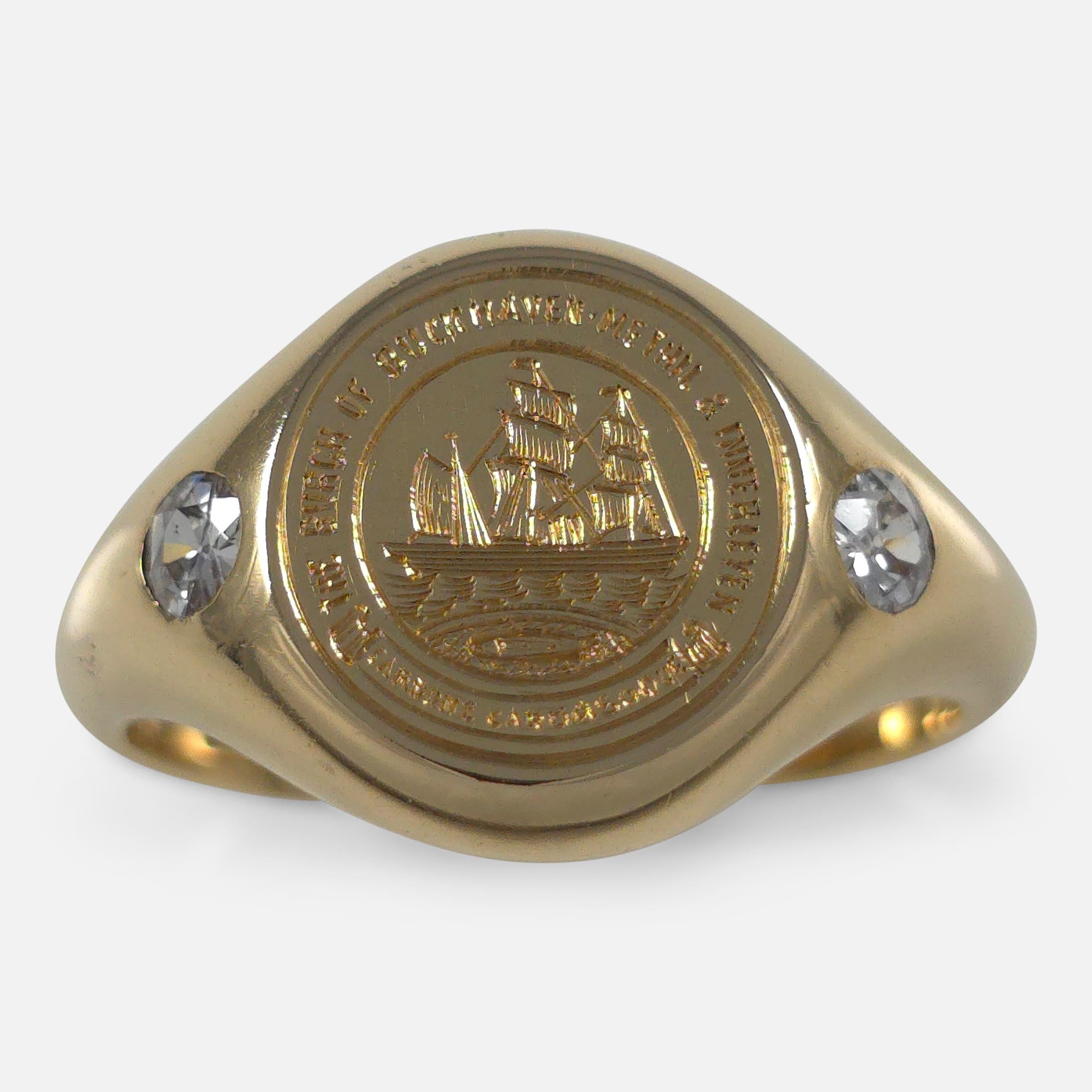 An 18ct yellow gold signet ring, featuring the intaglio arms of The Burgh of Buckhaven, Methil and Innerleven (Scotland). The ring is adorned with transitional cut diamonds totaling approximately 0.28ct and is presented in its original ring box.

•