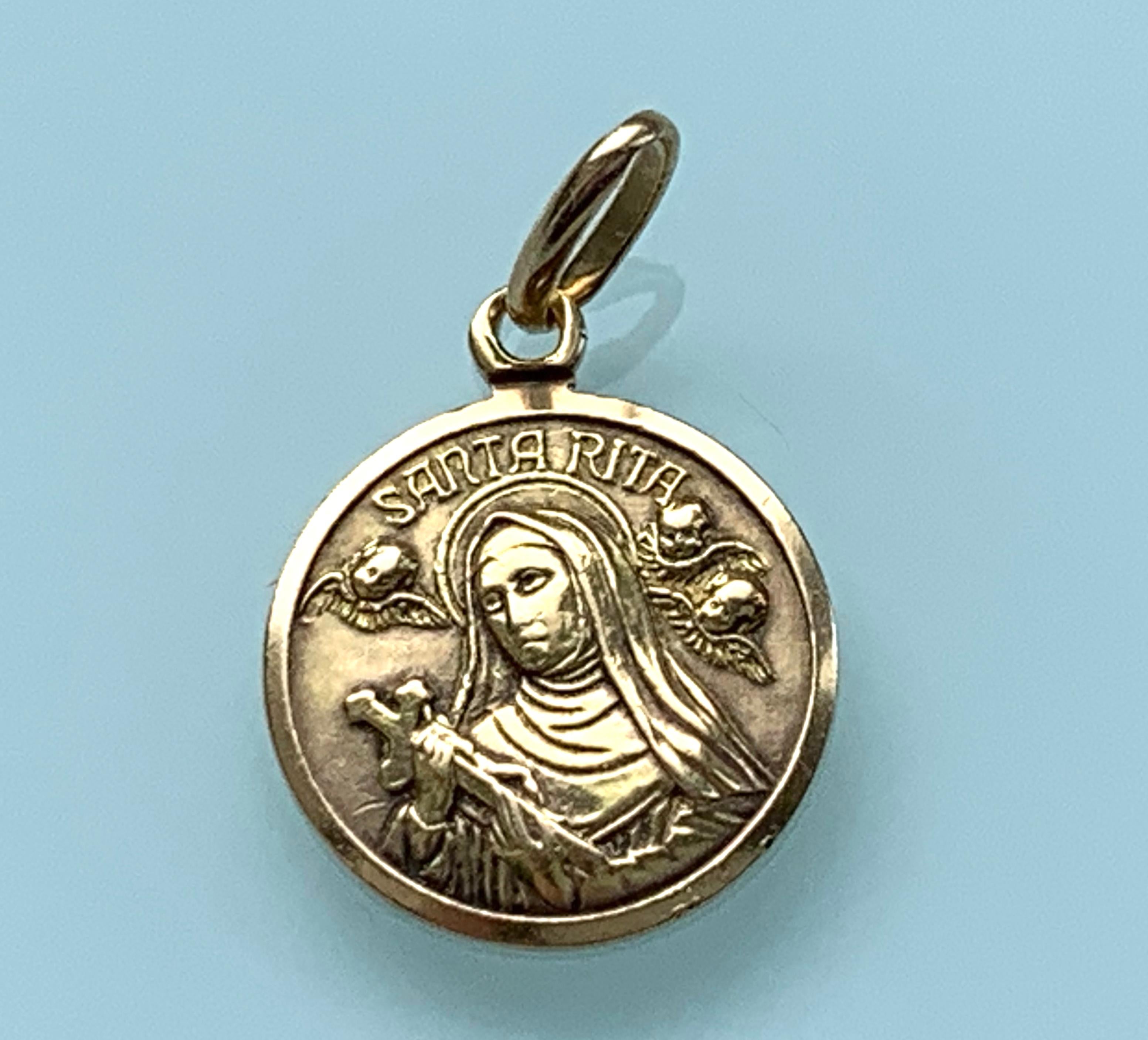 Beautiful Italian Religious Pendant
Depicting Santa Rita with surrounding cupids
Stamped 750 and Italian provence mark on reverse.
Dated  1944 - 1968
Makers number 