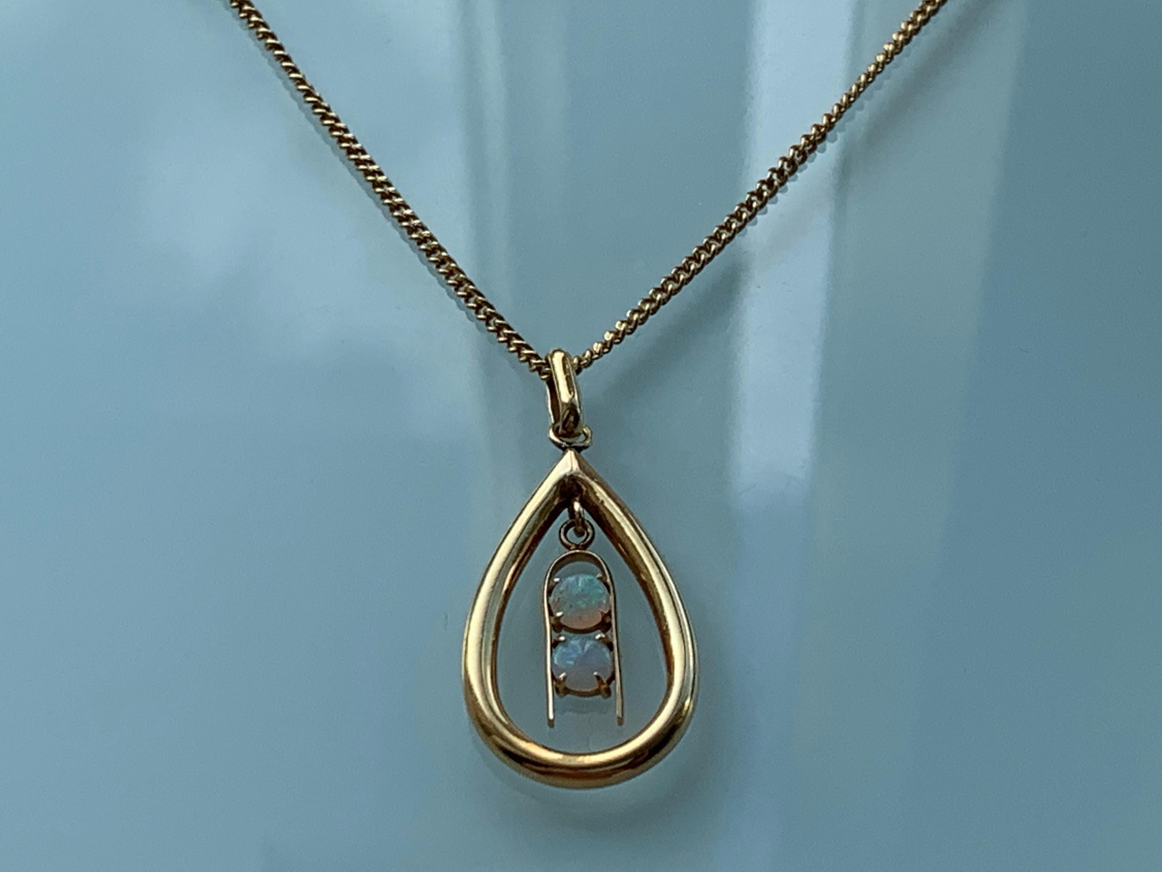 18ct Gold Opal Pendant
with Matching 18ct Gold Chain .
Rare Vintage Design with timeless appeal 
Pear Shaped Pendant has a swinging central section which is holding two Natural Opals
Stamped 18k on bail
Flag symbol and 750 on one side of chains