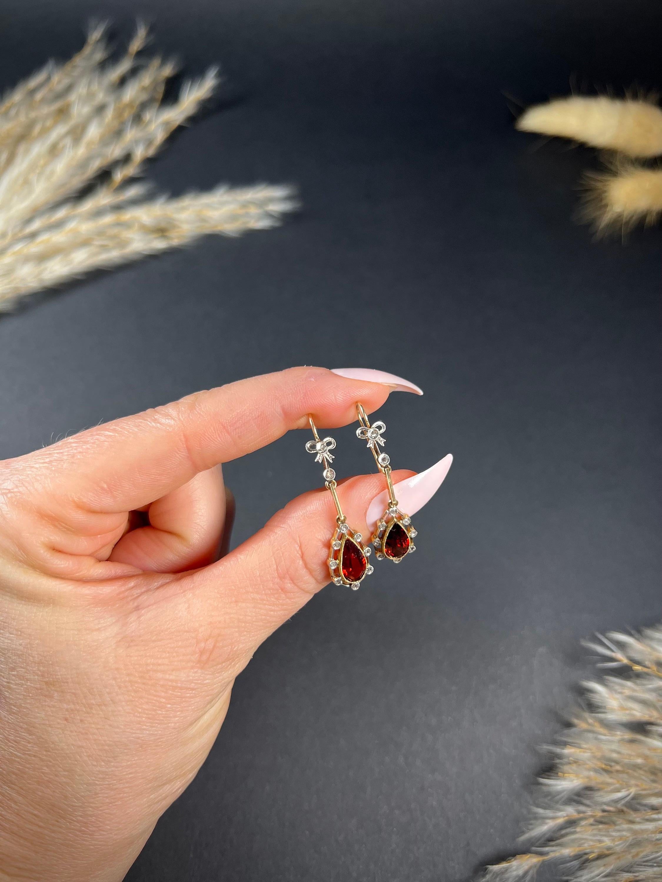 Antique Garnet Drop Earrings 

18ct Gold & Platinum Tested

Circa 1910

These Edwardian drop earrings are a true work of art. Crafted from 18ct yellow gold, they feature fabulous teardrop garnets that are surrounded by a halo of natural rose-cut