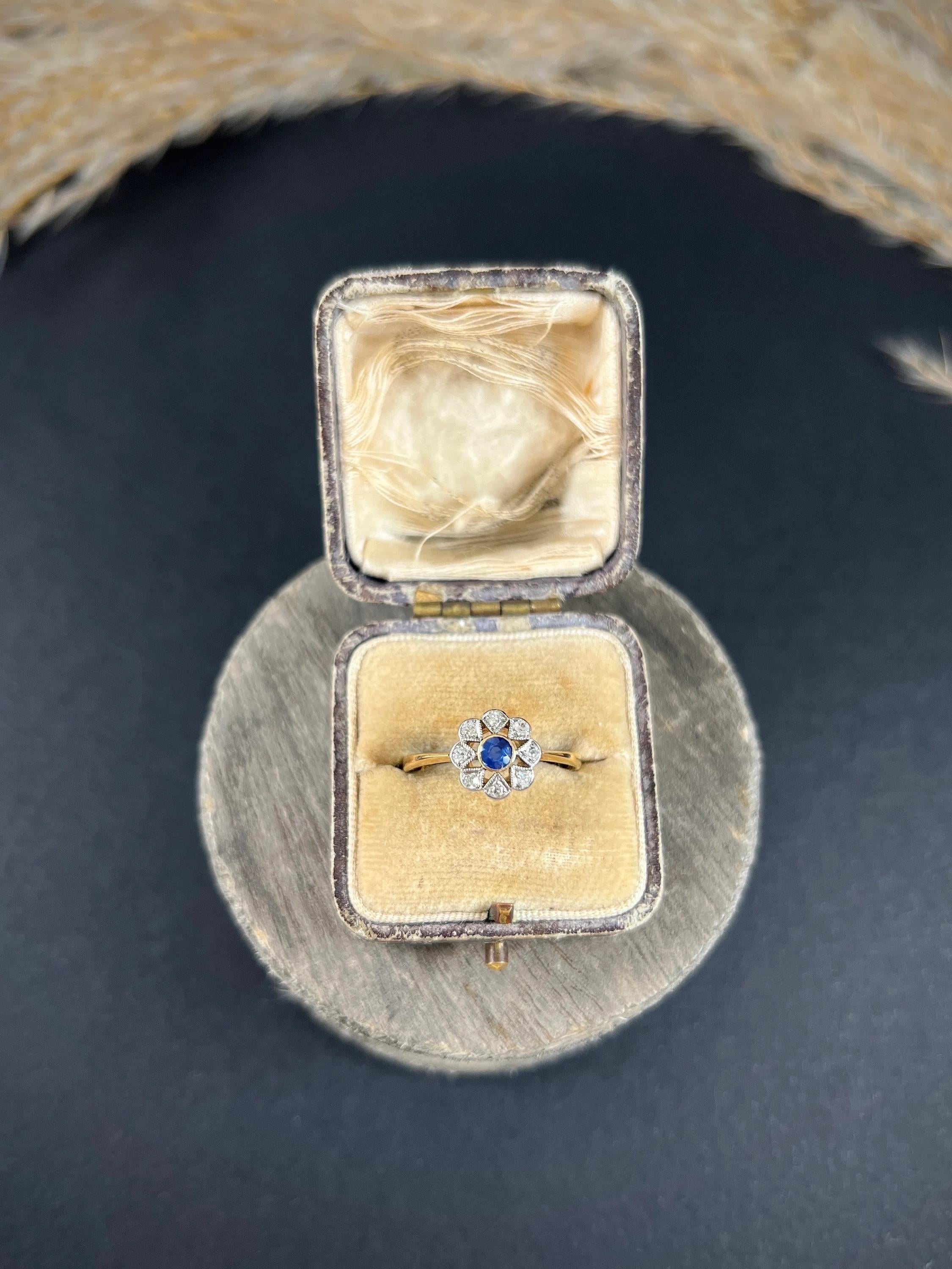 Antique Daisy Ring

18ct Gold & Platinum Stamped 

Circa 1910

This stunning Edwardian ring is crafted from elegant 18ct yellow gold and features a beautiful, natural sapphire at its centre. The sapphire is surrounded by a dazzling array of natural