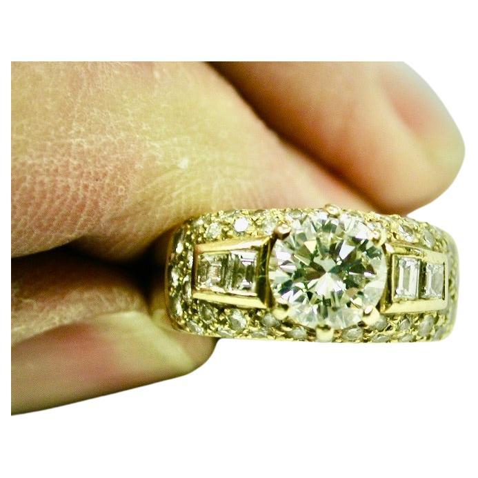 18ct Gold Ring Set With 1 Carat Diamond Centre Stone And A Cluster Of Diamonds.
The Ring was made in London by Lawrence of Hatton Garden.
All the diamonds have a good colour.