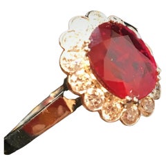 18ct Gold Ring Set With A Ruby Surrounded By Brilliants