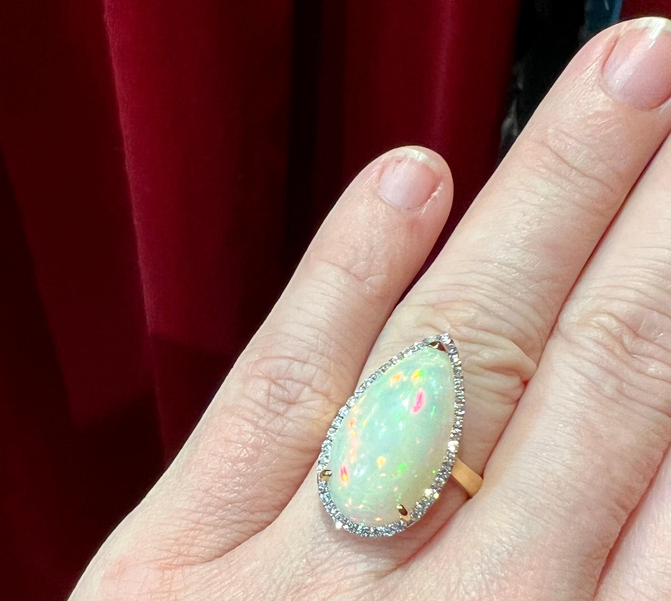Round Cut 18ct Gold Ring Set with an Opal Surrounded by Diamonds