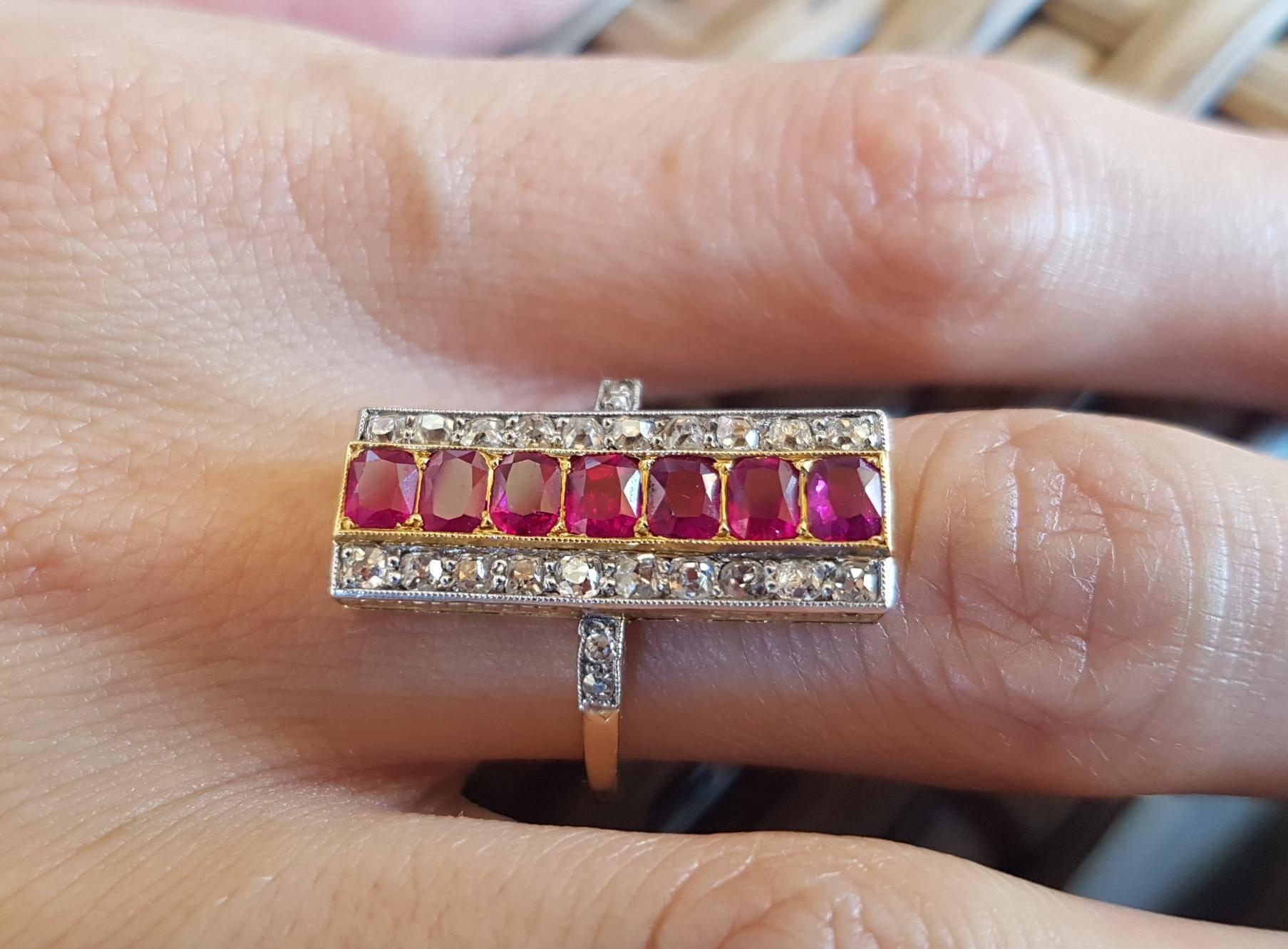 Stunning long art deco ruby and diamond plaque ring. Set with 7 rectangle calibre cut pink red natural Burmese rubies of approx 2.10ct and 20 old cut diamonds of approx 0.70ct total and 4 shoulder diamond of 0.01ct each. Platinum set. Head measures