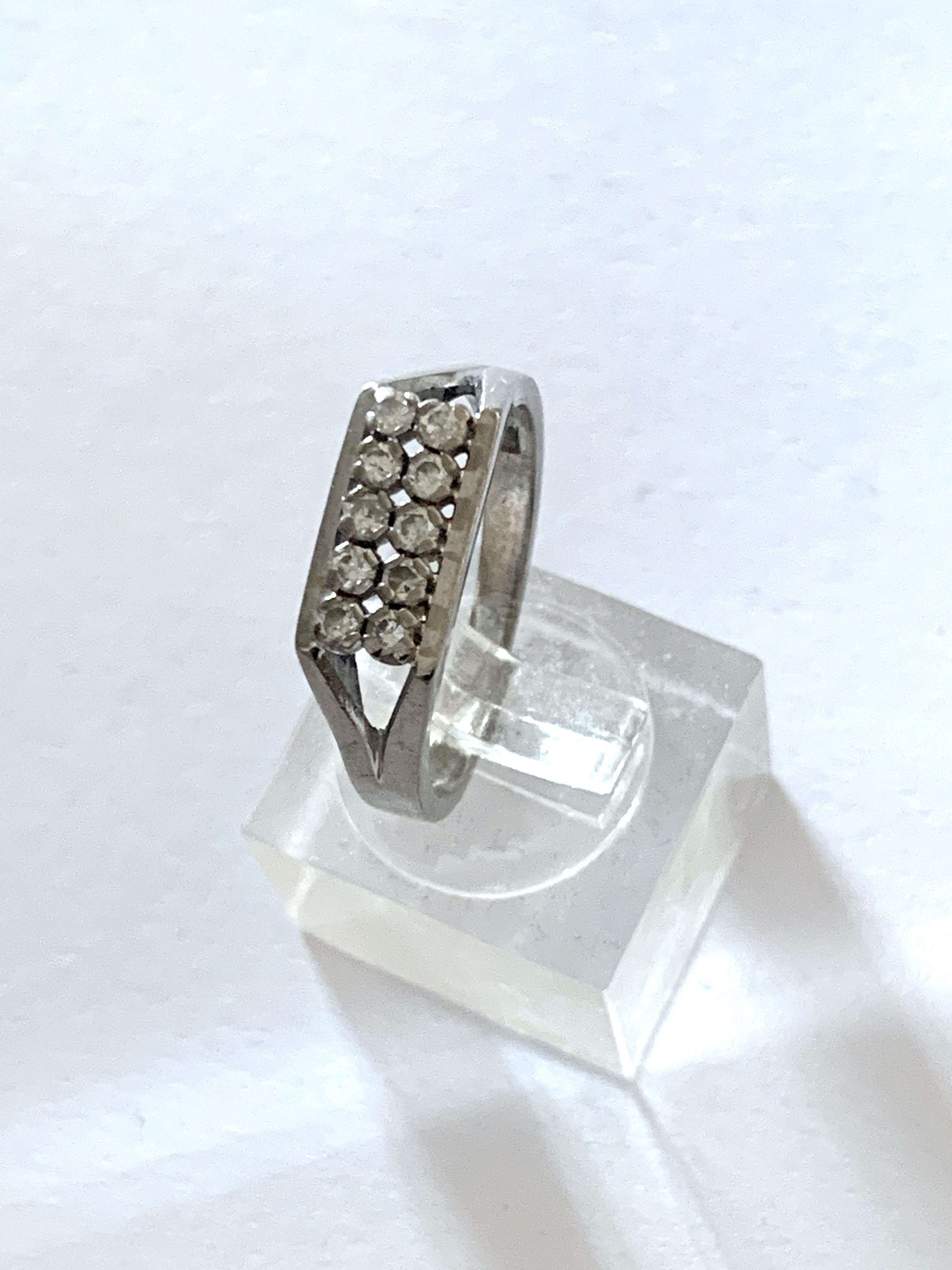 18ct 750 White Gold 0.3 Carat Diamond Ring
Full British Hallmarks
Circa 1970s

10 x 2mm diamonds Natural Diamonds
which are very lively and of good quality

Weight of Ring 4.87 grams