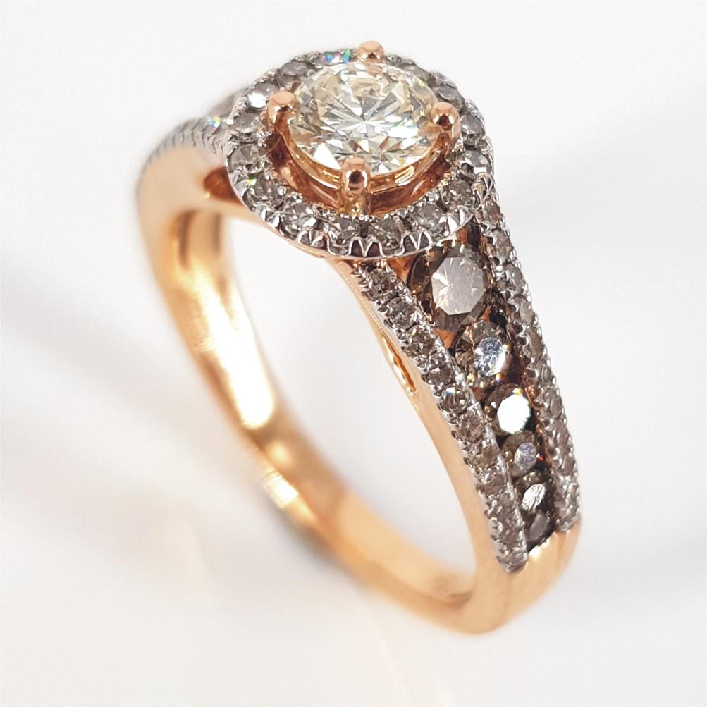 Strong, striking and pronounce, this ring says it all. Set in 18carat rose gold and weighing 5.48 grams, this ring features 1 RBC Diamond as its main stone, weighing 0.36carat of MN/vs quality, 2 0.10carat, 2 0.05carat and 2 0.02carat Cognacs, with