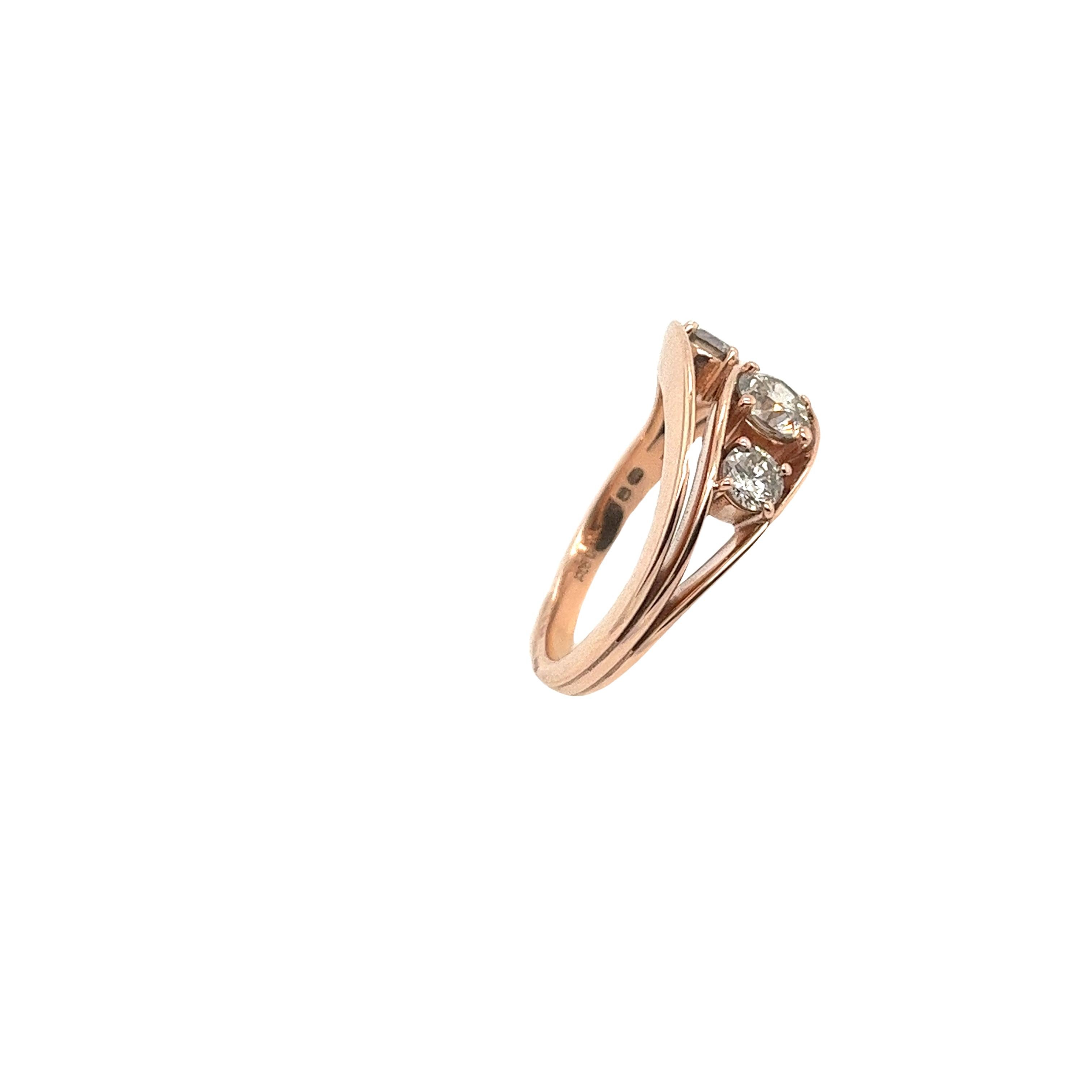 This gorgeous diamond 3-stone ring set in an 14ct rose gold setting, 
with 0.90 carats natural round brilliant cut diamonds.
This is a unique and eye-catching ring.
Total Diamond Weight: 0.90ct
Diamond Colour: P
Diamond Clarity: SI
Total Weight: