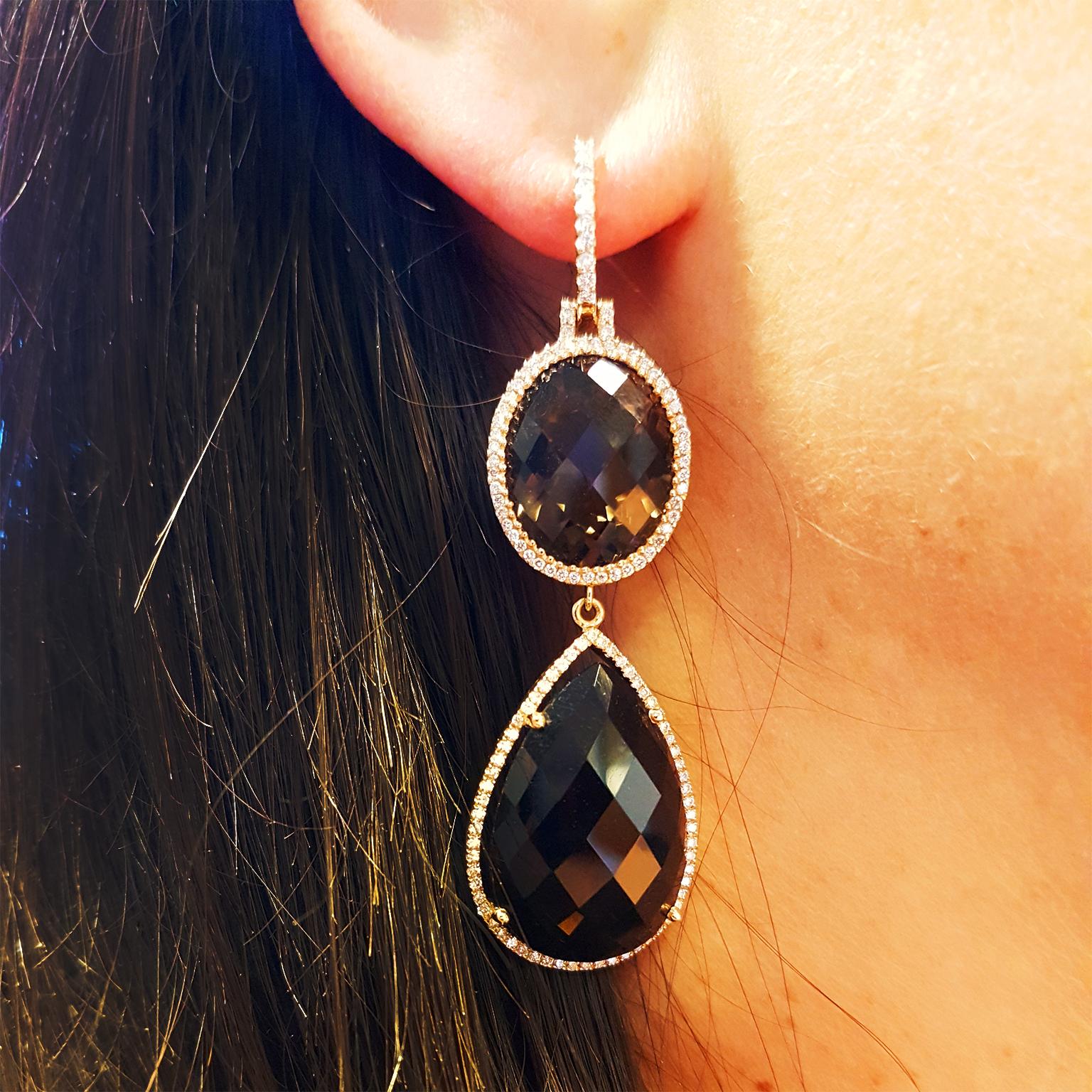 THE NATURAL TONES OF AFRICA COME TO LIFE! 

These stunning gala hanging earrings have been crafted in 18k Rose Gold and set with 1.10ct of glittering fine diamonds (G-VS) and almost 64ct of specially-faceted cognac-coloured Swiss Smokey Quartz