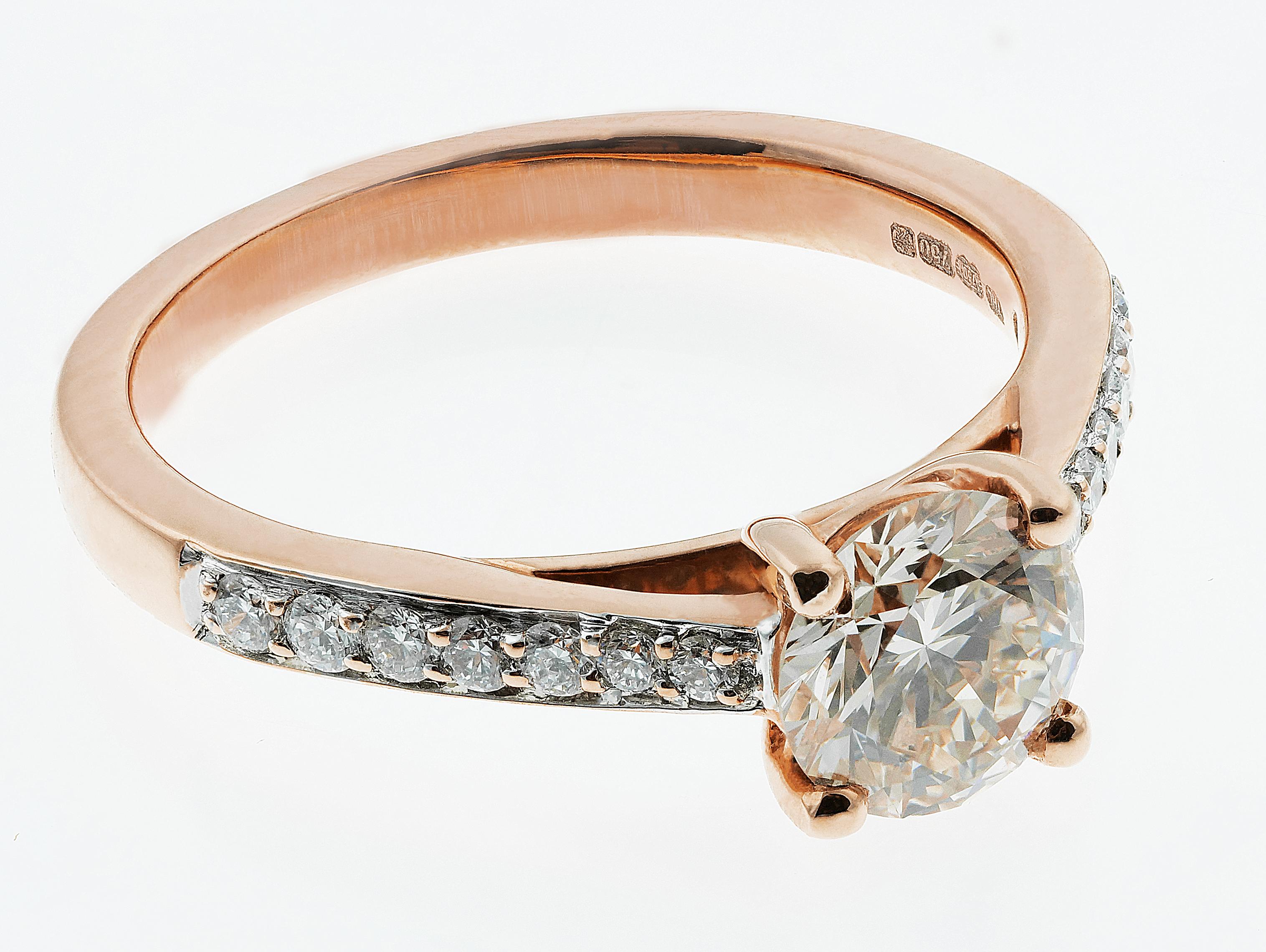 Beautiful 18 ct Rose gold diamond ring consisting of a glistening round brilliant cut diamond, accompanied by 14 diamonds on the shoulders along the finite rose gold band.
1 x Round Brilliant Cut Diamond, carat weight: 0.85 carats, assessed colour: