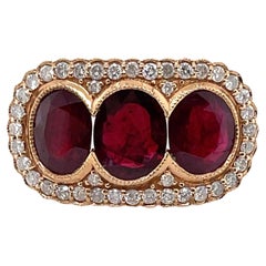 Bague en or rose 18 carats avec trilogie de rubis et diamants