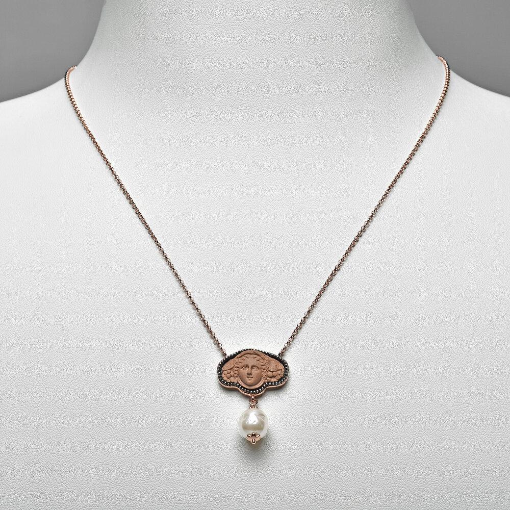18ct rose gold vermeil and fine porcelain
Handmade in Italy

Athena, once a beautiful priestess, turned into Medusa, a snake-headed monster as restitution for an affair. Her union with the sea god Poseidon broke a promise of sexual abstinence. Her