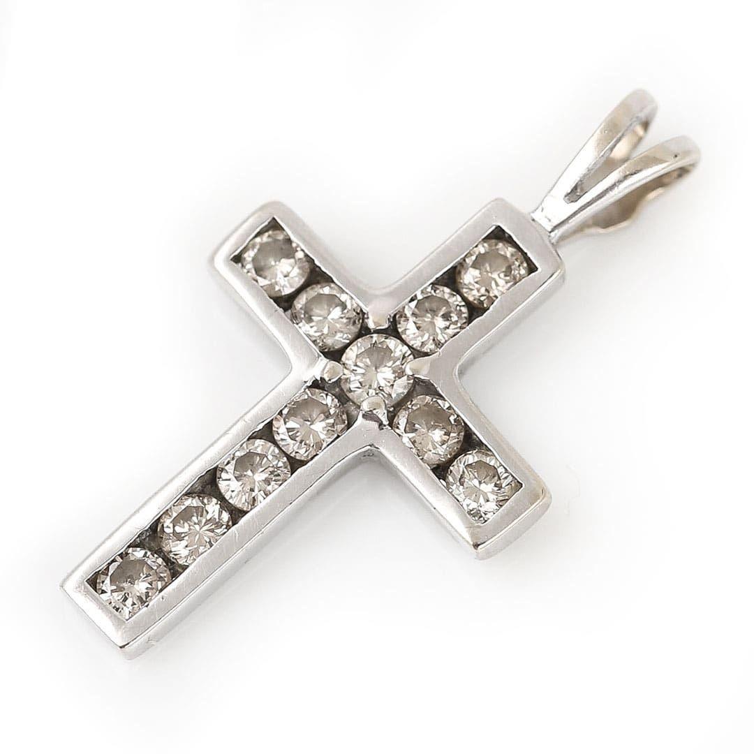A stylish and sweet 18ct white gold brilliant cut diamond cross or cruciform pendant. The dainty cross measures 21mm high by 13mm wide and is channel set with a total of 0.34ct of bright and lively diamonds. The cross could be used as a single