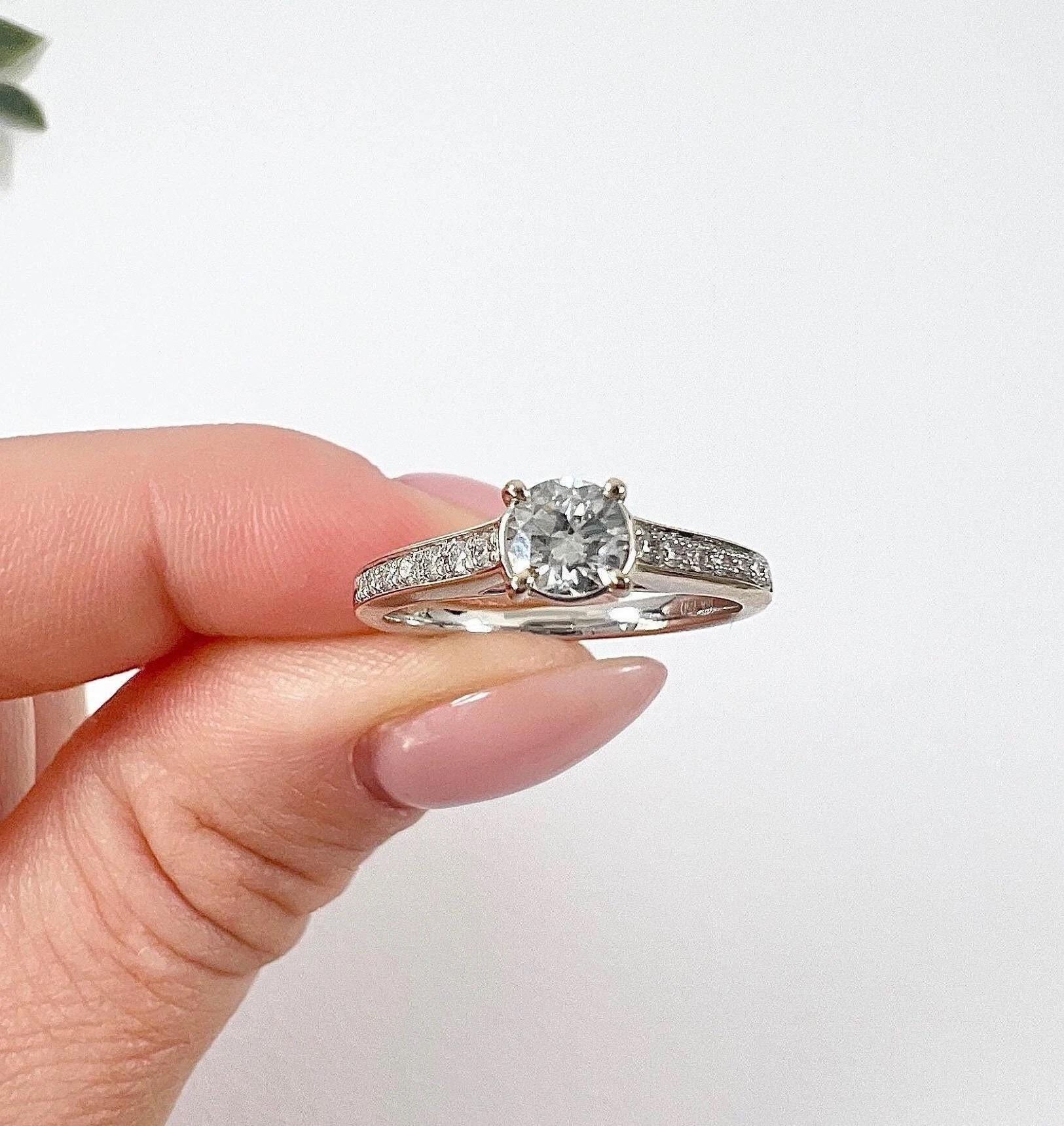 Diamond Ring

18ct White Gold

Circa 1920s Diamonds

Introducing a stunning 18ct white gold stamped engagement ring featuring brilliant cut stones that have been repurposed from a 1920s brooch. These exquisite stones have been meticulously set into