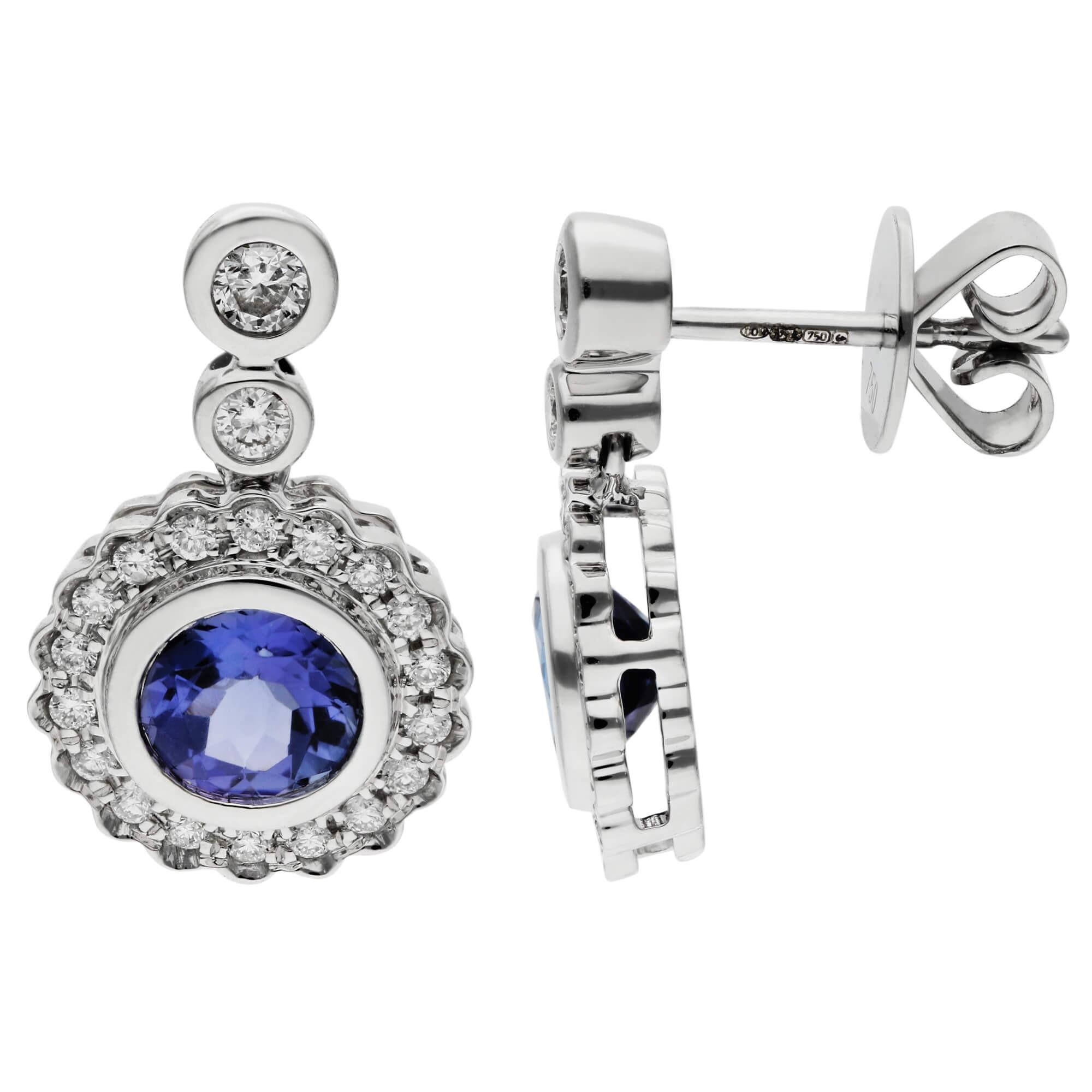 18ct White Gold 1.00ct Tanzanite & 0.45ct Diamond Halo Drop Earrings

Experience the allure of our 18ct White Gold Tanzanite & Diamond Halo Drop Earrings, where luxury and elegance meet. Each earring showcases a mesmerizing round, bezel-set