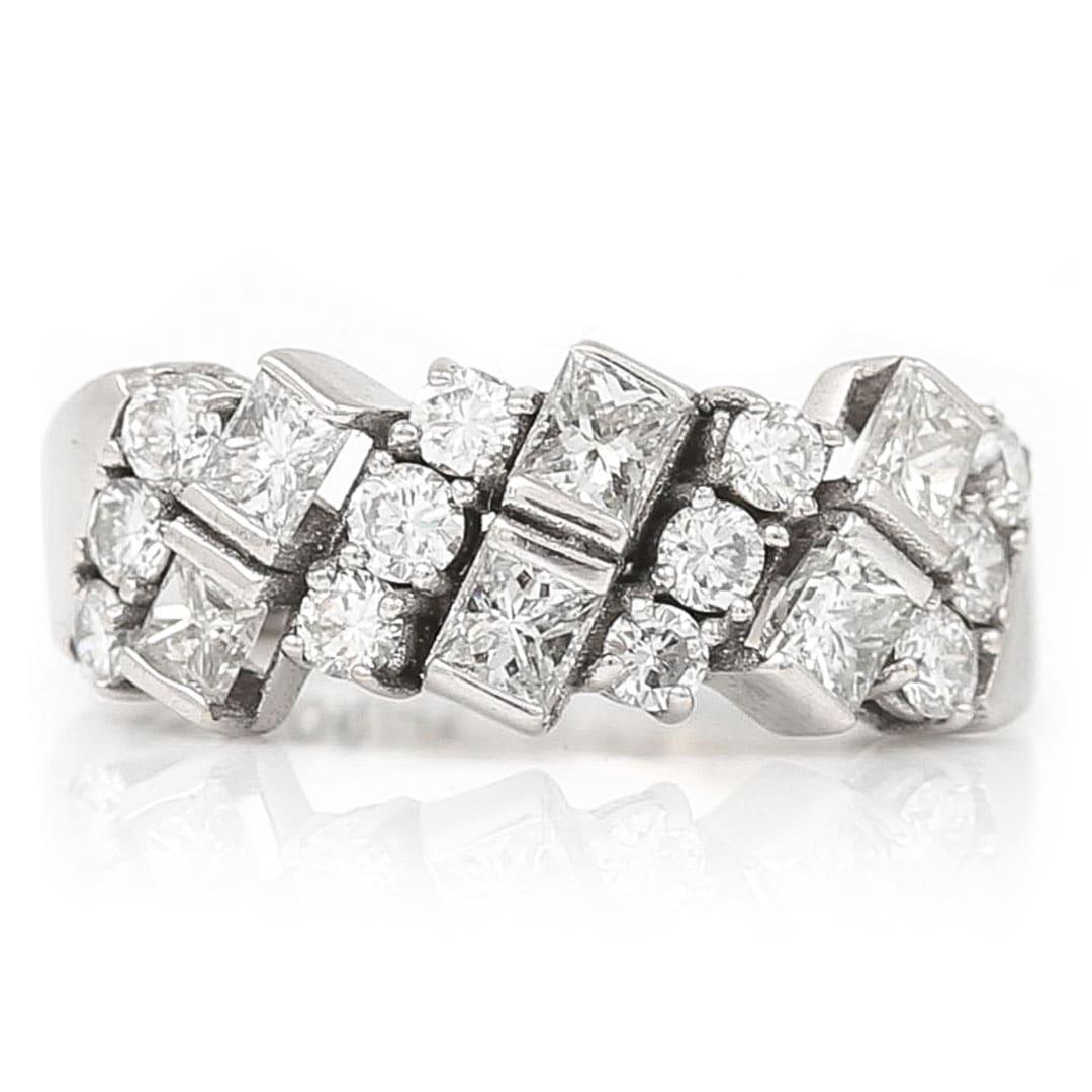 A stunning and unique 18ct white gold half eternity ring set with 1.25cts of princess and brilliant cut diamonds its design and setting offering more than the typical eternity band. The design is comprised of rows of three brilliant cut diamonds
