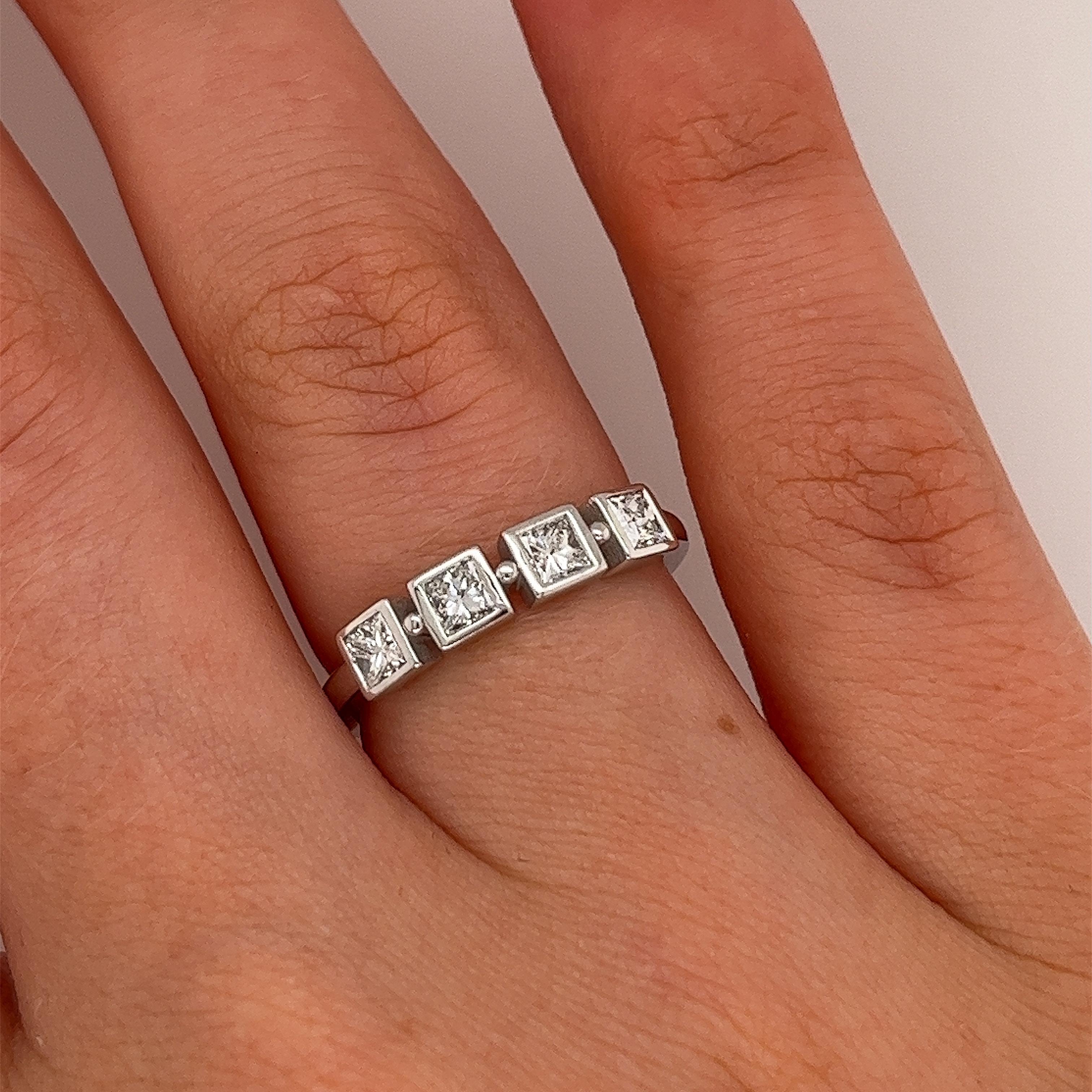 Add a touch of sophistication and elegance to your jewellery collection 
with this stunning 18-white gold ring. Featuring four brilliant princess cut diamonds totaling 0.52ct, this ring is a perfect blend of classic design and modern style, 
making