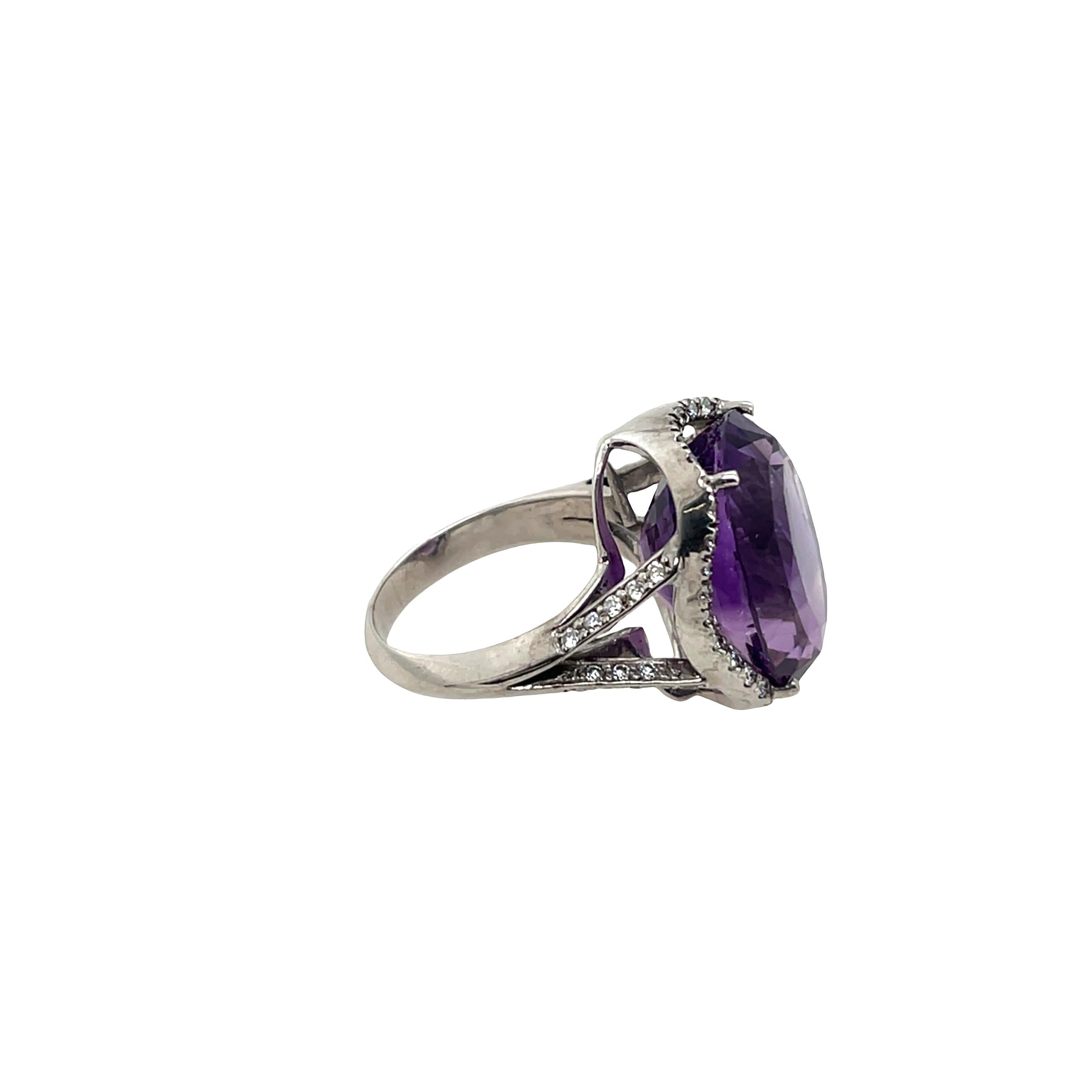 Elegant and eye-catching, this exquisite ring 
features a vibrant purple amethyst at its centre, 
surrounded by a dazzling halo of natural diamonds. 
The contrast between the deep hue of the amethyst 
and the sparkle of diamonds is beautifully