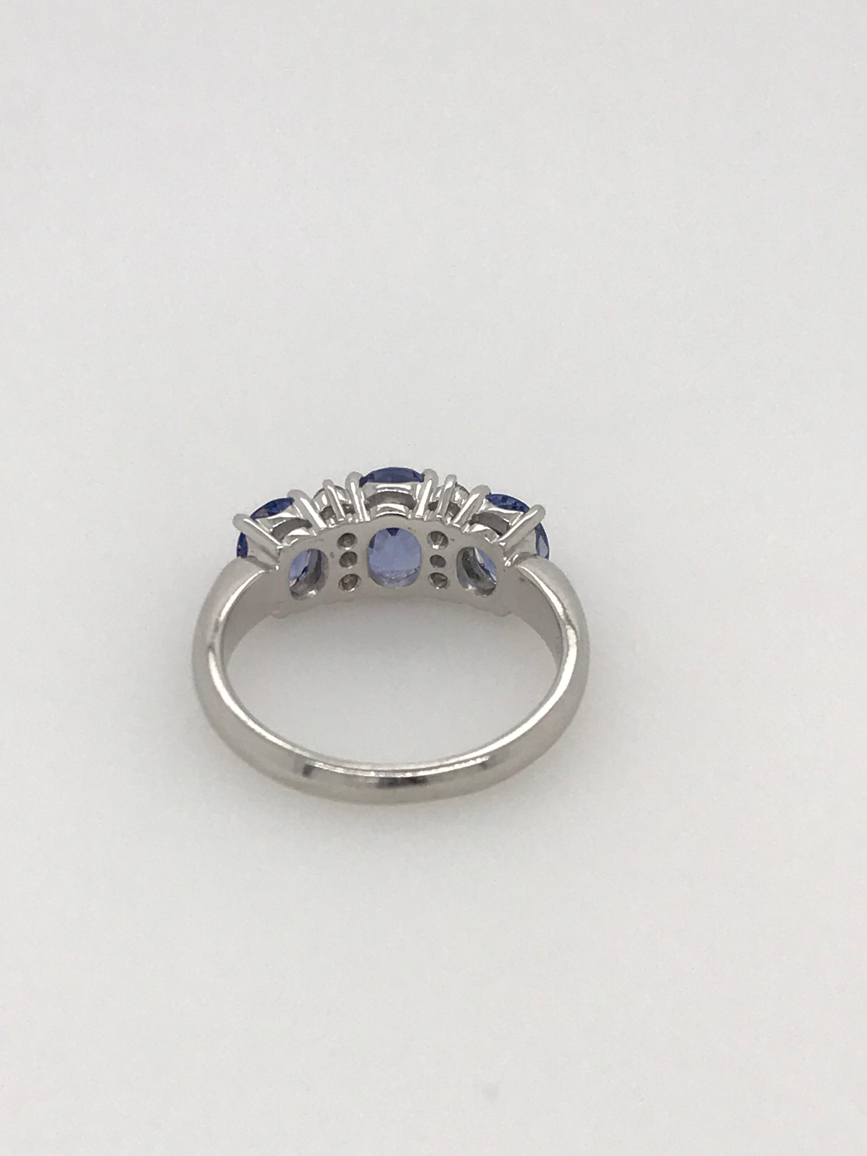 This beautiful ring has 3 matching oval Ceylon sapphires and 6 brilliant cut diamonds set in 18ct White Gold 
The 3 sapphires total 2.90ct and the 6 diamonds total 0.16ct. The band is rounded and tapers from 3.3mm at the shoulder to 2.3mm.
Ring size