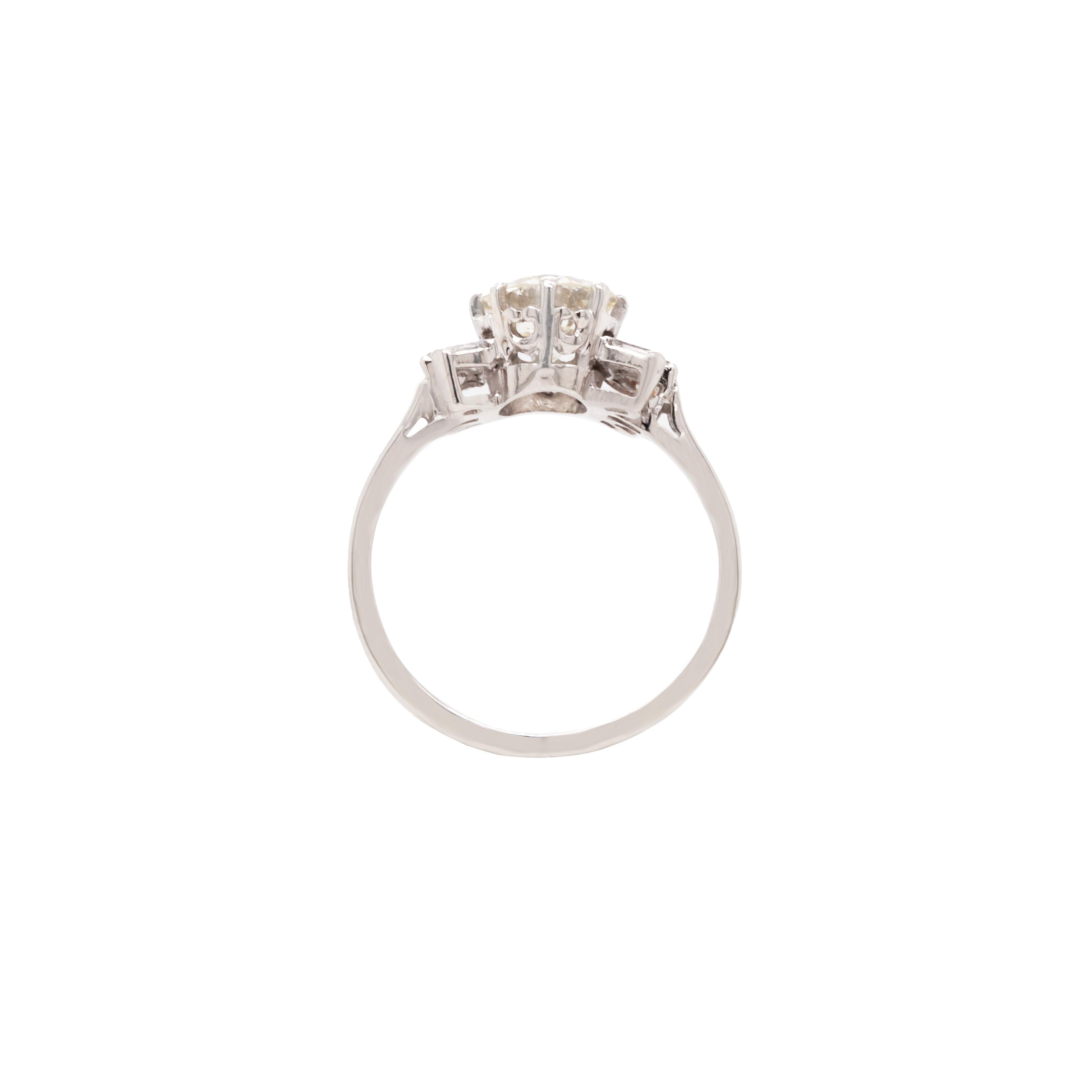This beautiful diamond spray cluster ring exudes mid-century vintage glamour. A gorgeous round brilliant cut diamond, estimated at VS1/VS2 clarity and weighing 1.32 carats, is claw set in an elegant 18ct white gold and platinum ring. The centre