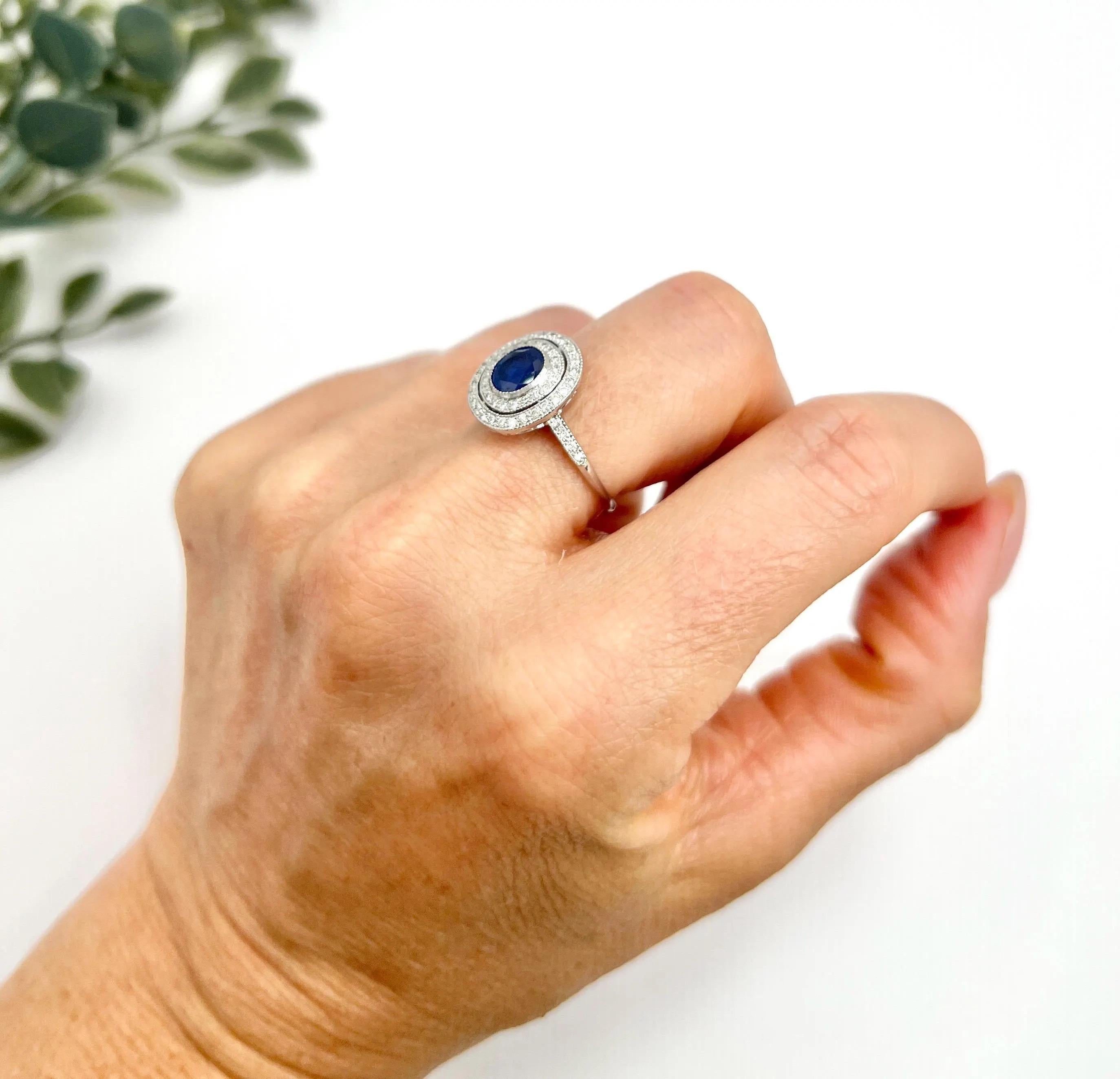 Preloved Sapphire Halo Ring 

18ct White Gold Stamped 750

Circa 2000

Step into a world of vintage elegance with this stunning Art Deco style ring, crafted in luxurious 18ct white gold. The design features a captivating double halo, or target