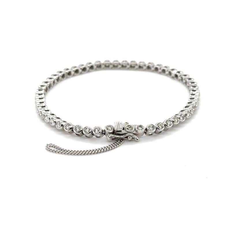 A shiny and sleek classic modern tennis bracelet with round brilliant diamonds bezel set into 18ct white gold.  Taking a high polish, this is a piece that shines and sparkles!

Assessed diamond weight: 1.60cts
Assessed diamond quality: H/VS
Total